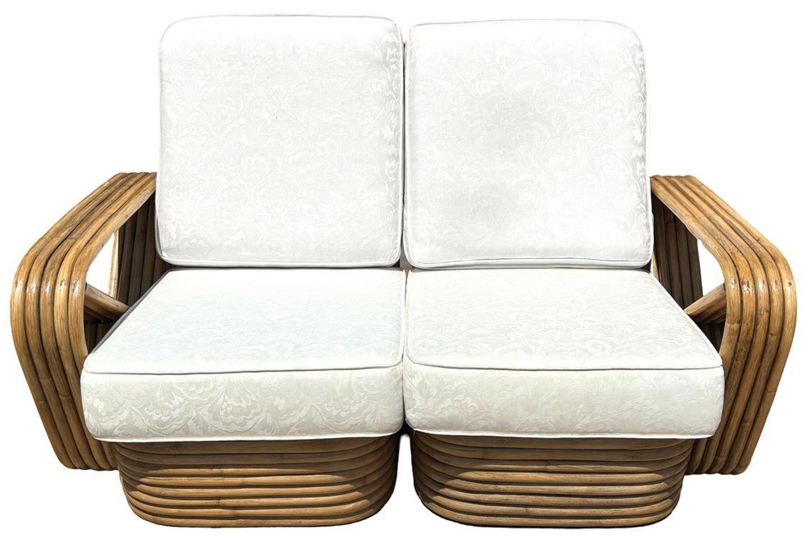 This restored mid-century rattan five-strand square pretzel three-seat sectional settee with sectional pieces showcases timeless charm styled after the design made famous by Paul Frankl. Crafted with solid construction five-strand arms and stacked