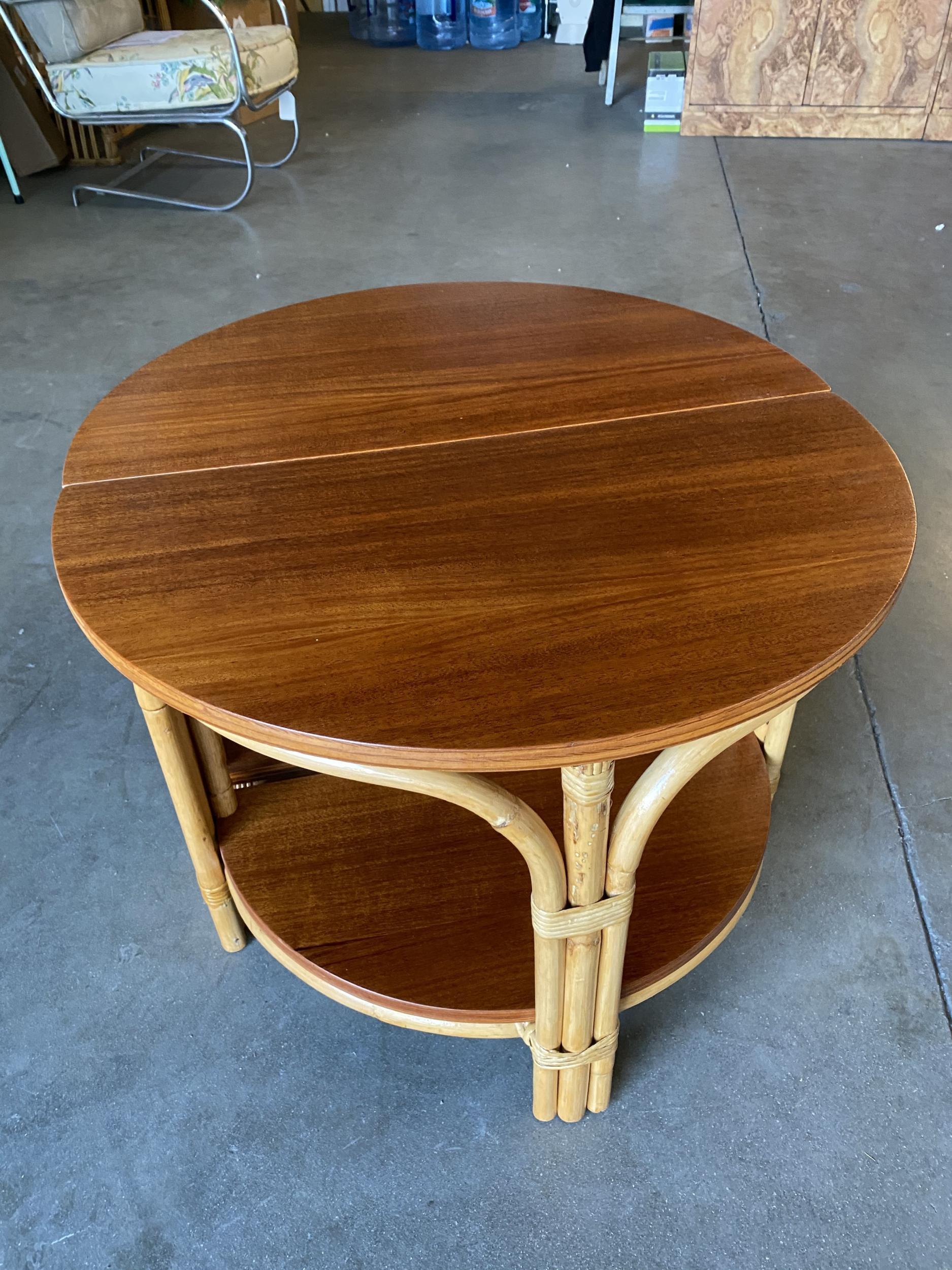 Rare pair of half-round rattan coffee tables, the pair both feature a half circle design with a rattan base and solid mahogany top. Both tables fit together perfectly to make a complete circle. 

Restored to new for you.

All rattan, bamboo, and