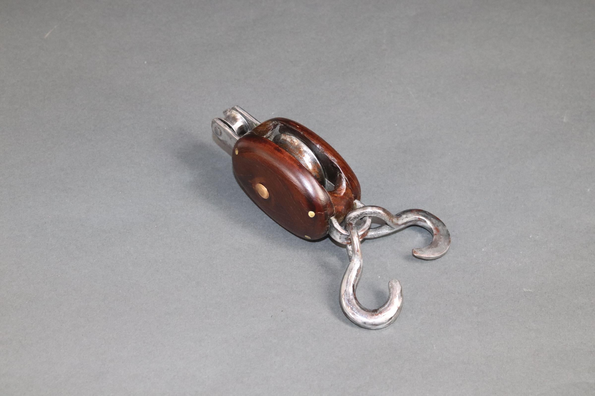 Varnished wood yachting pulley with polished hooks and tether ring. Weight is 1 pound. X-125