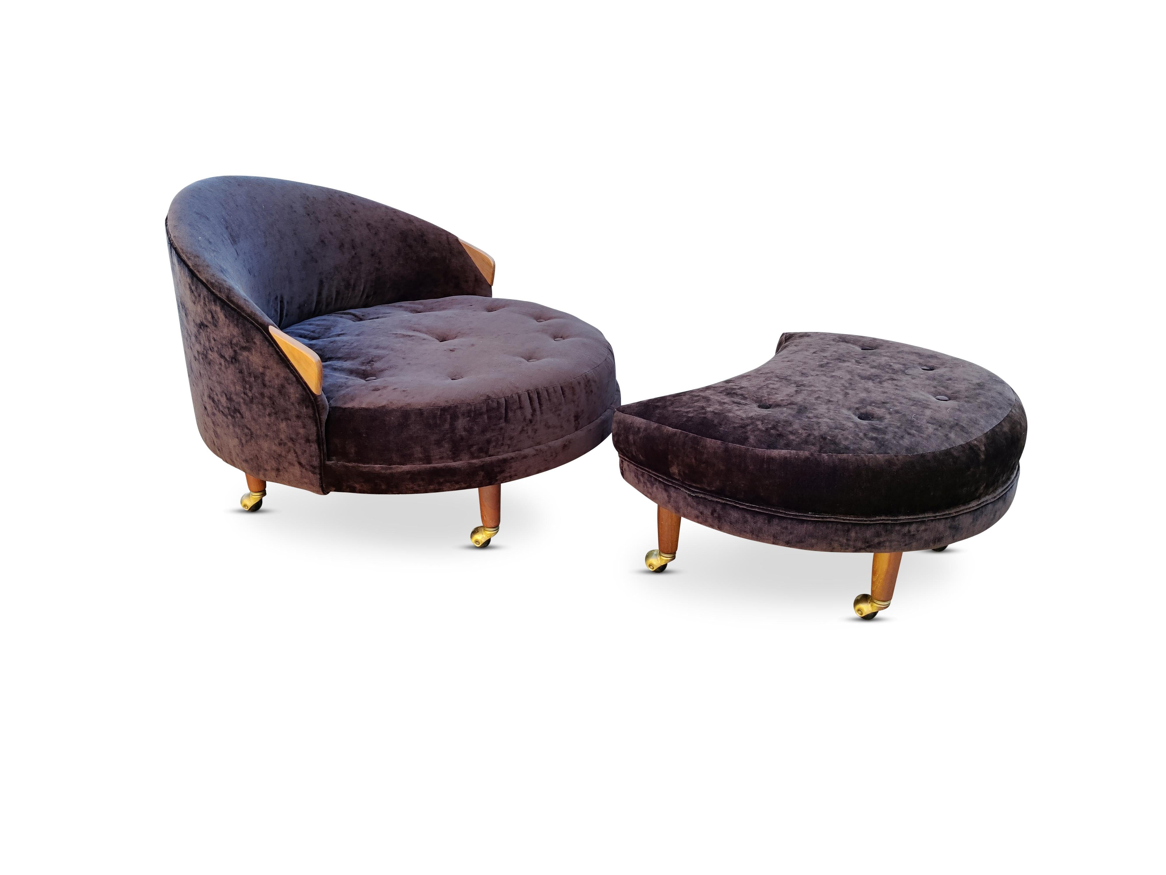 This large sized and spacious 'Havana' chair and ottoman by Adrian Pearsall was designed and produced in the 1960s. This gorgeous example features a recently recovered brown veloure upholstry and walnut arms and legs with brass casters and delicate