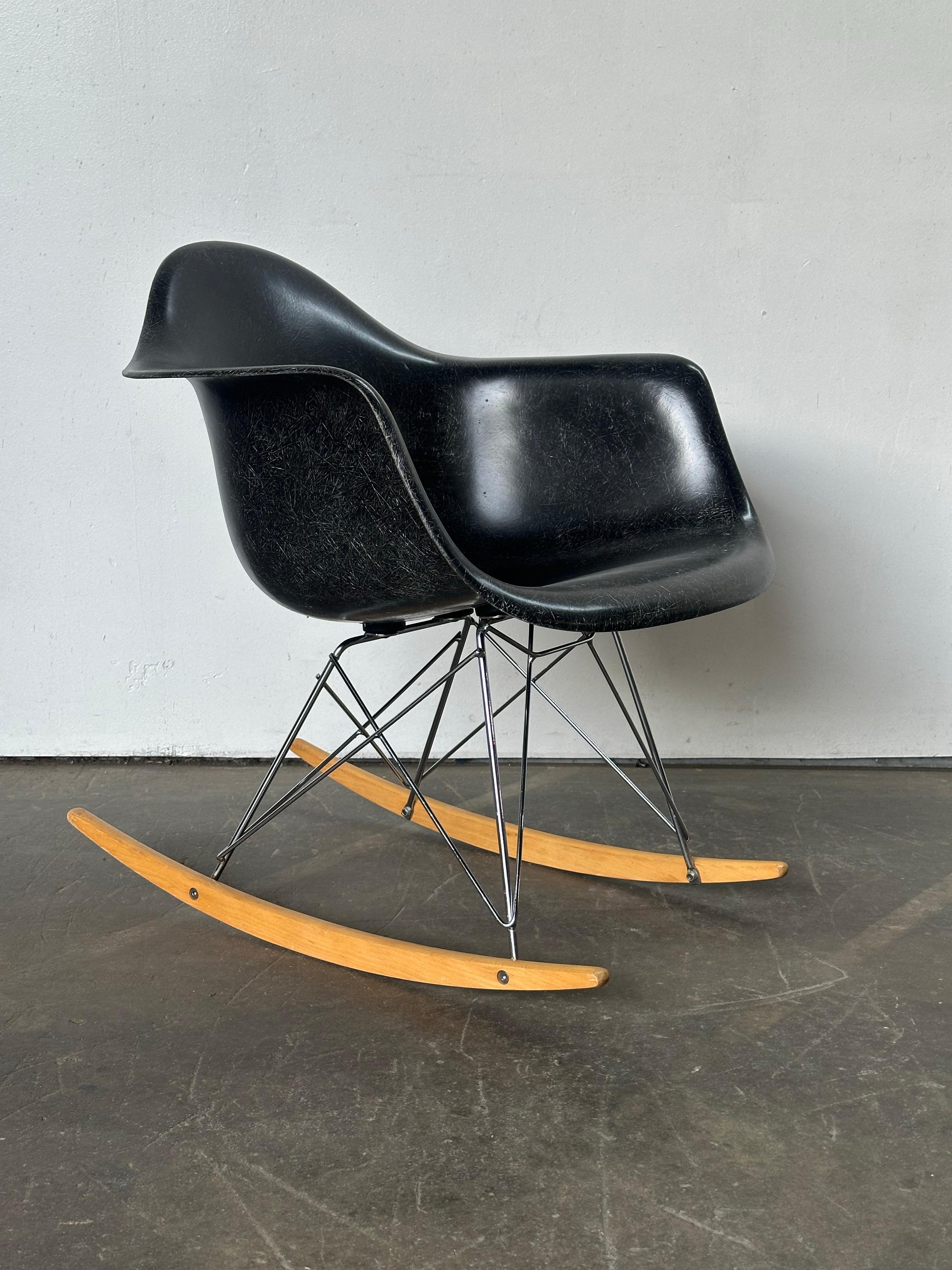 Restored 1960s Herman Miller Eames chair. Vintage fiberglass shell on later base of steel and wood runners. Signed and guaranteed authentic. Embossed with Herman Miller emblem underneath the chair. Features new rubber shock mounts, freshly adhered