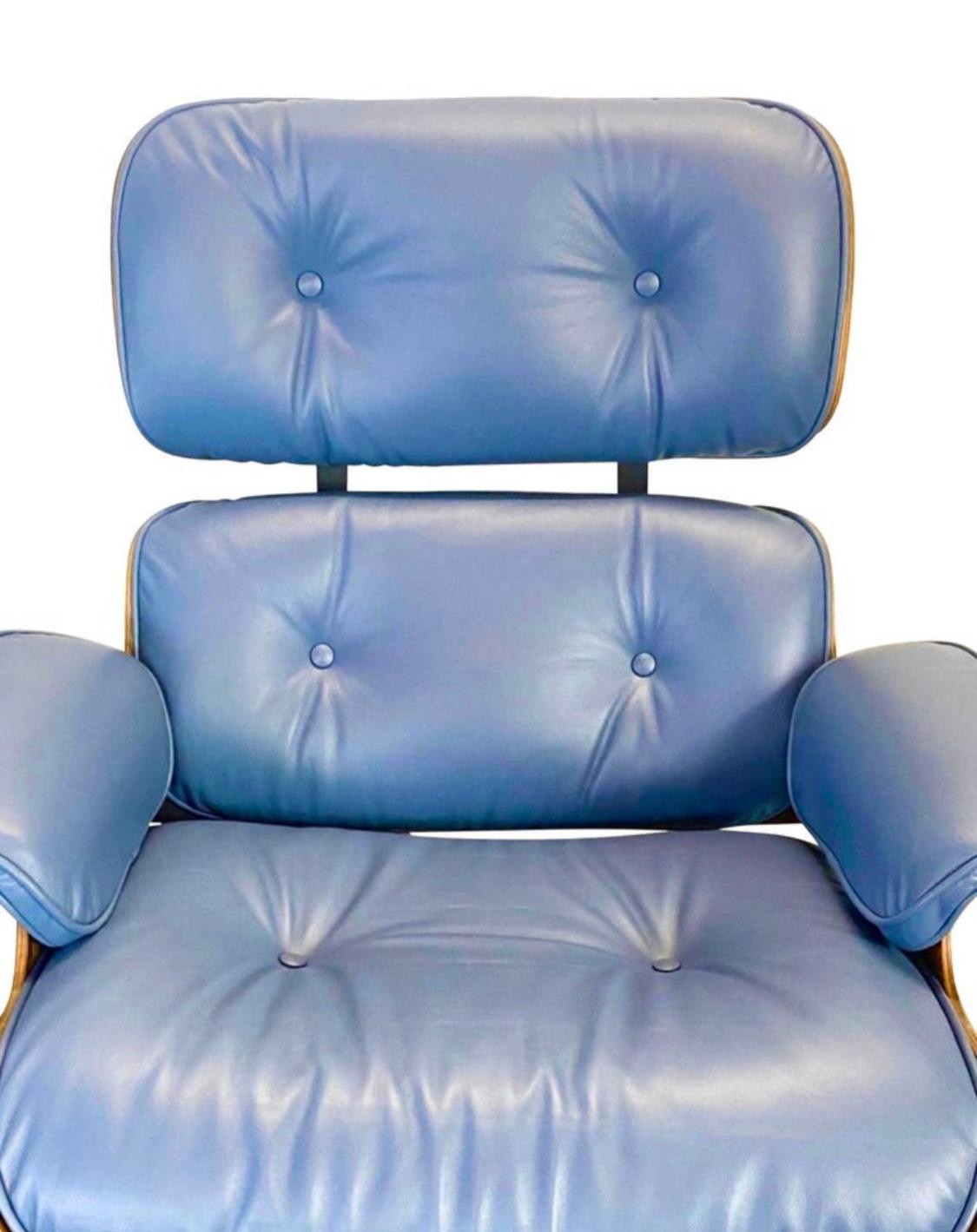 A restored vintage signed and authentic Herman Miller Eames lounge chair and ottoman in rose wood with custom new blue leather cushions with smooth and comfortable finish. The wood is cleaned and oiled, no missing parts or damages besides normal