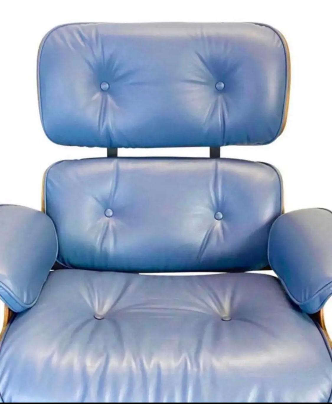 A restored vintage signed and authentic
Herman Miller Eames lounge chair and ottoman in rose wood with custom new blue leather cushions with smooth and comfortable finish. The wood is cleaned and oiled, no missing parts or damages besides normal