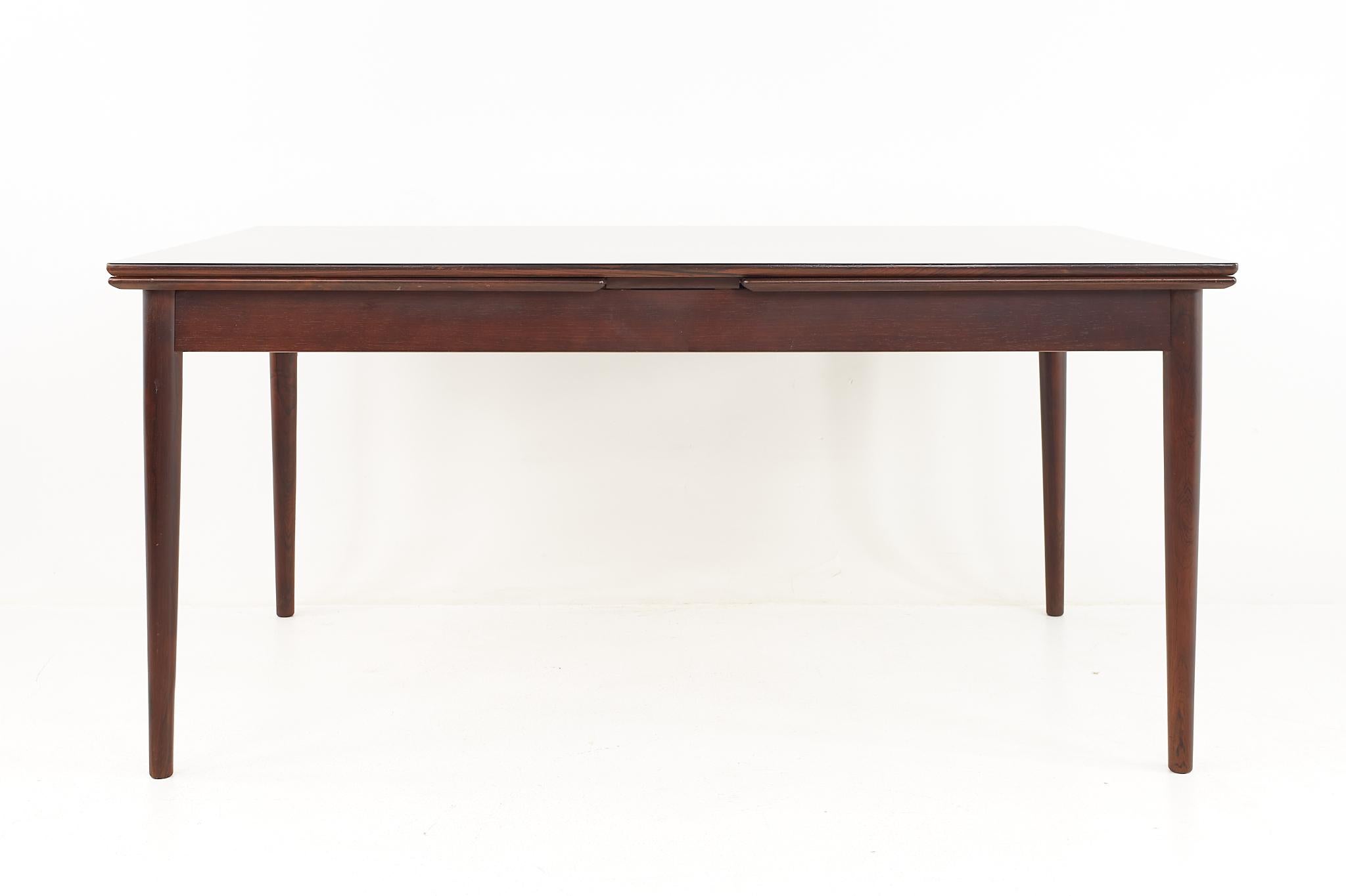 Restored Hornslet Danish mid century rosewood hidden leaf dining table

This table has been restored and is ready to ship.

Table measures: 62.5 wide x 39.5 deep x 29 inches high; each leaf is 27.5 inches wide, making a maximum table width of