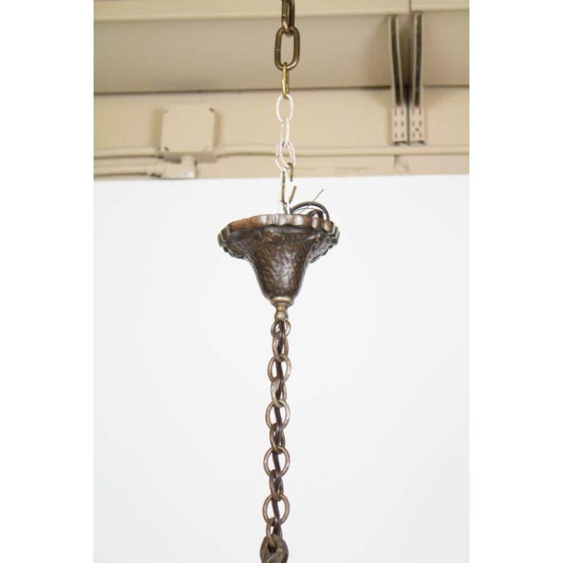 Cast iron pendant fixture. Complete with original chain and canopy. Roped iron arms holding an iron basket. Has original dark patina, has been cleaned, wax polished and rewired with new electrical. Complete and ready to install. Overall minimum