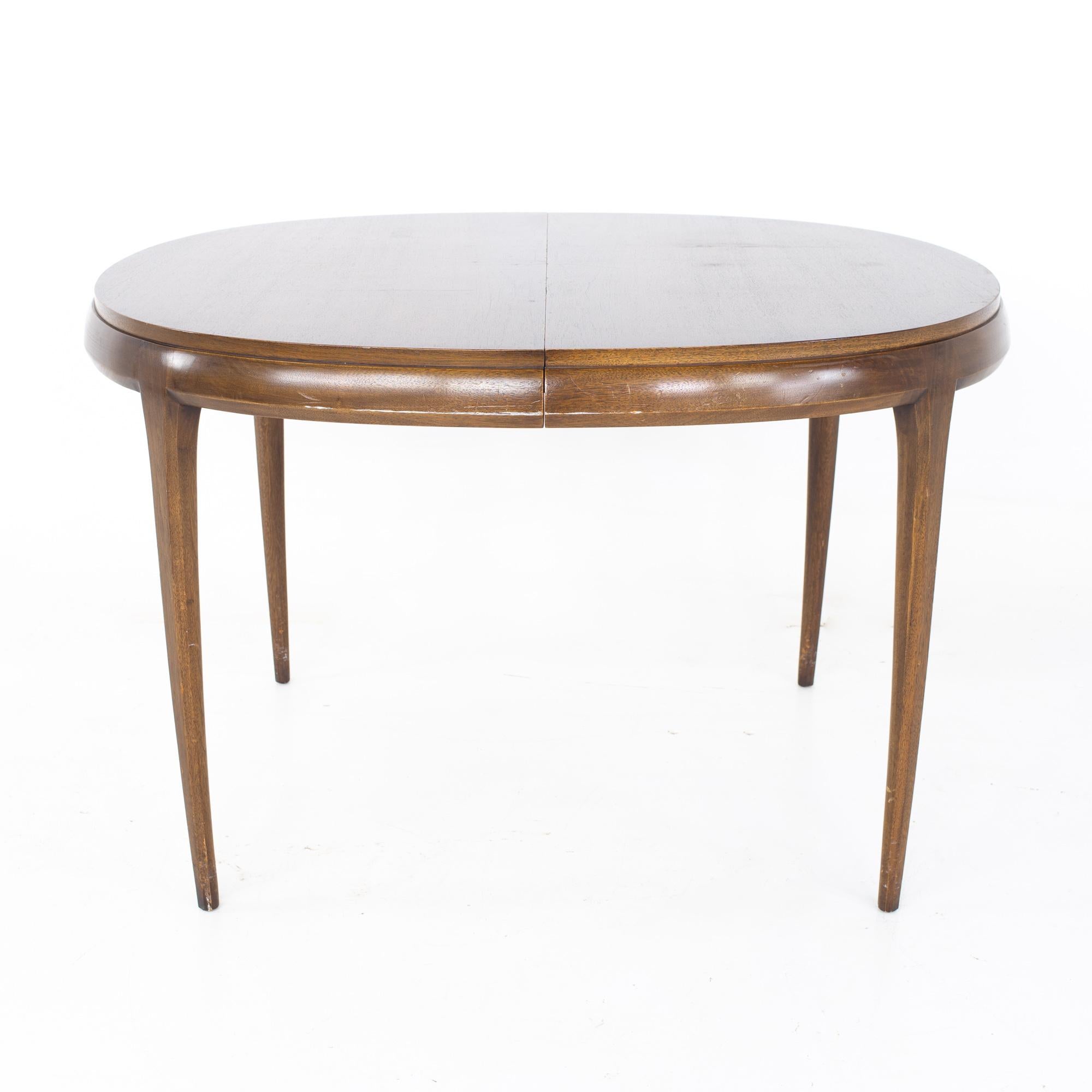Restored Lane Rhythm style mid century walnut round oval expanding dining table

PLEASE NOTE: This table has been restored and is ready to be shipped ASAP.

The table measures: 46 wide x 42 deep x 29.5 inches high; each leaf is 18 inches wide,