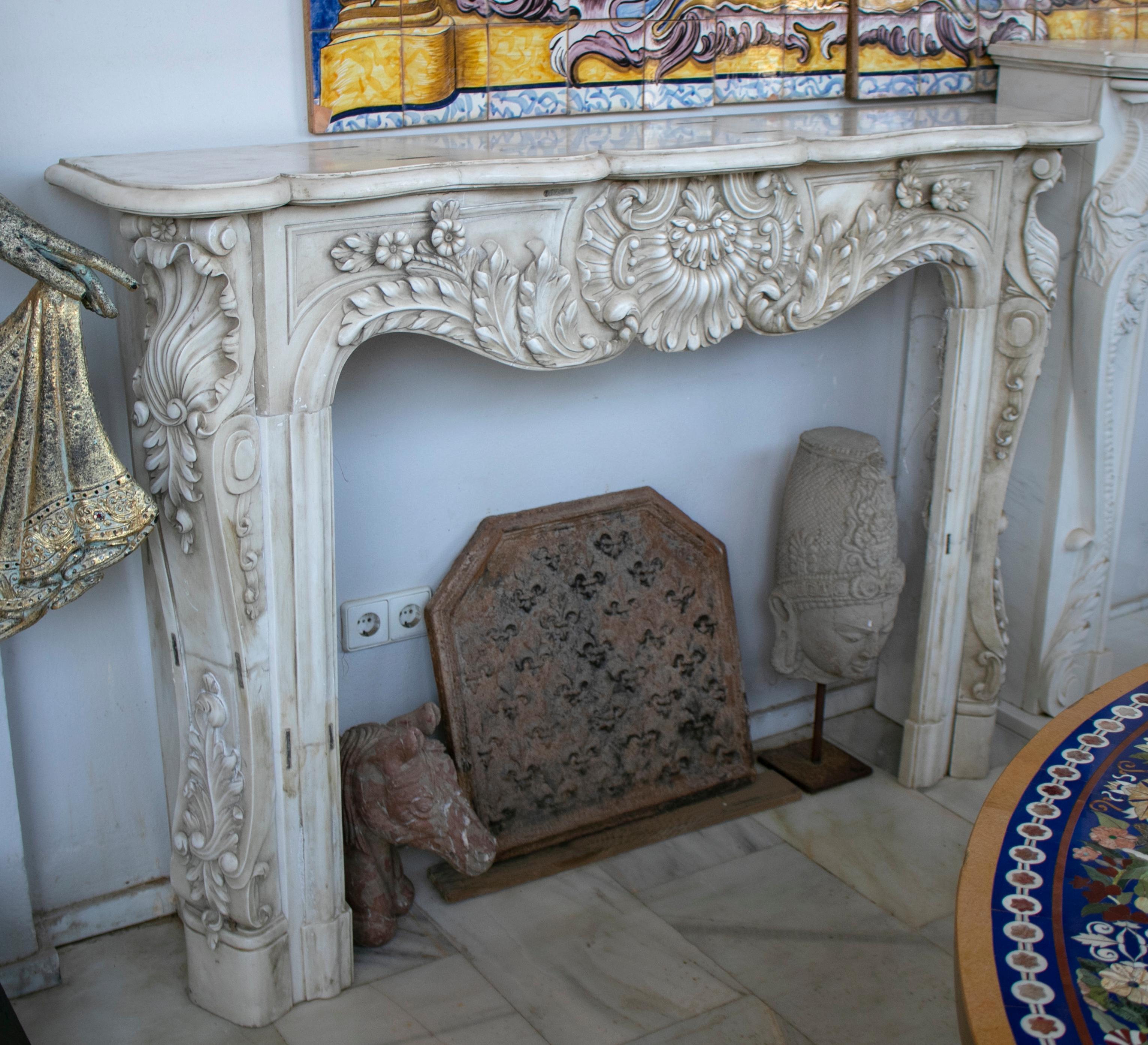 Restored Luis XV style aged white marble fireplace mantle.