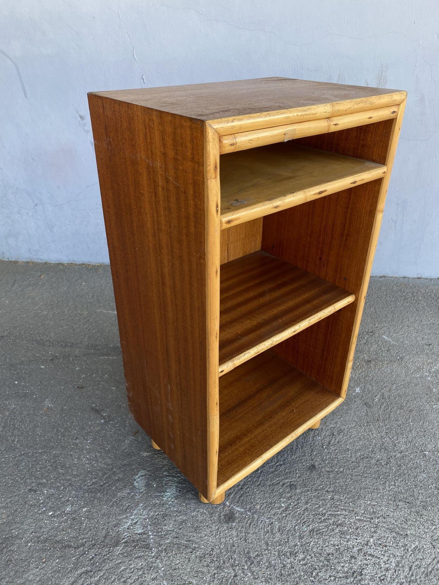 Restored post-war mahogany bedside table with rattan border featuring 3 shelves for storage.

Restored to new for you.

All rattan, bamboo, and wicker furniture has been painstakingly refurbished to the highest standards with the best materials.