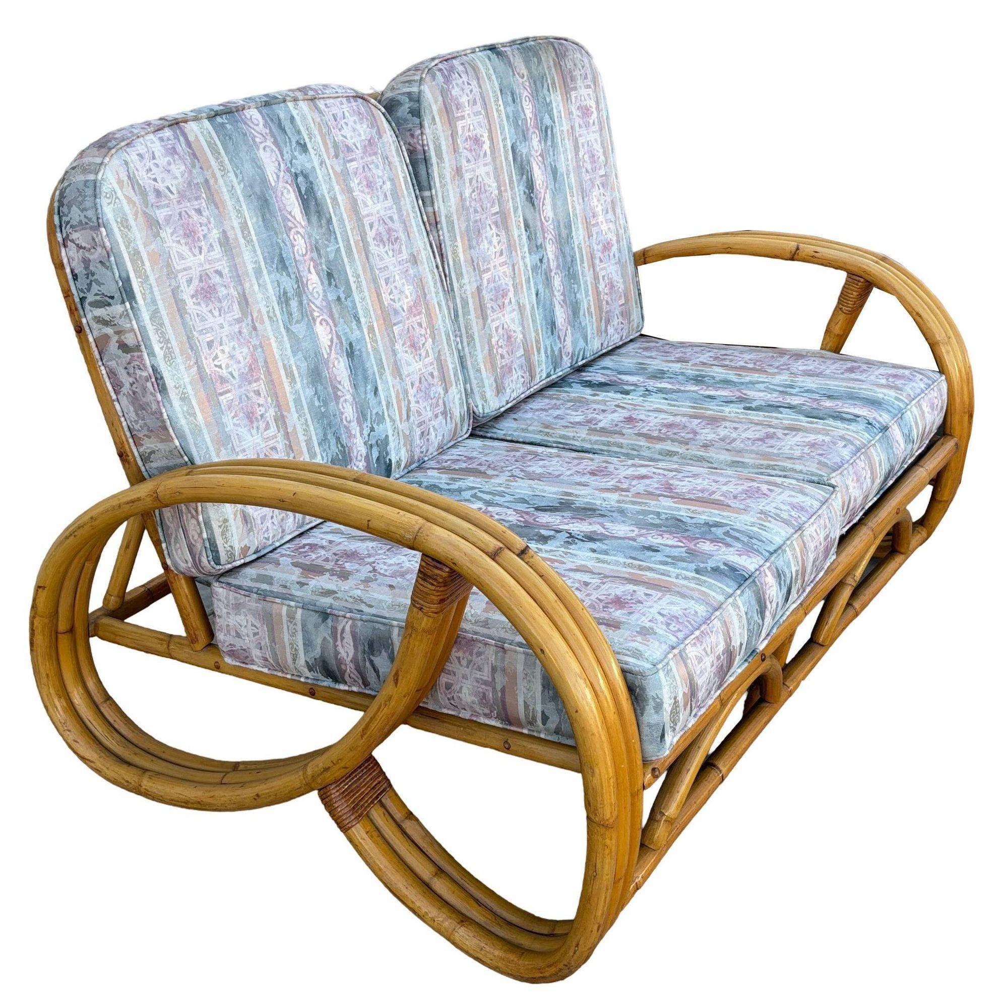 Made in 1950, this beautifully restored rattan 2-piece living room set showcases the iconic 3-strand 3/4 pretzel arm design, blending vintage charm with modern comfort. The set includes one sofa and one settee, both meticulously refinished to