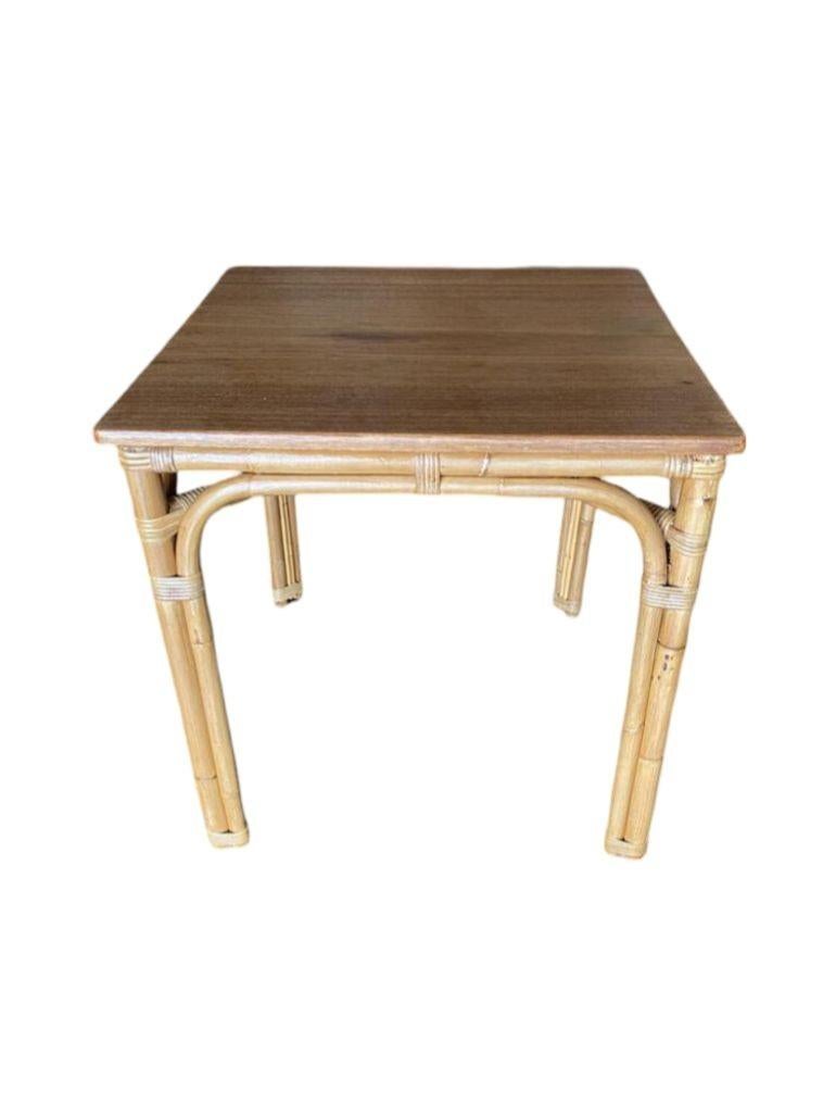Questo rarissimo tavolo da gioco in rattan restaurato presenta una meravigliosa base ad arco a 3 fili, un rivestimento in vimini fantasia e un bellissimo piano in mogano tinto medio. Il tavolo ricorda molto gli am designs resi famosi da Paul Frankl.