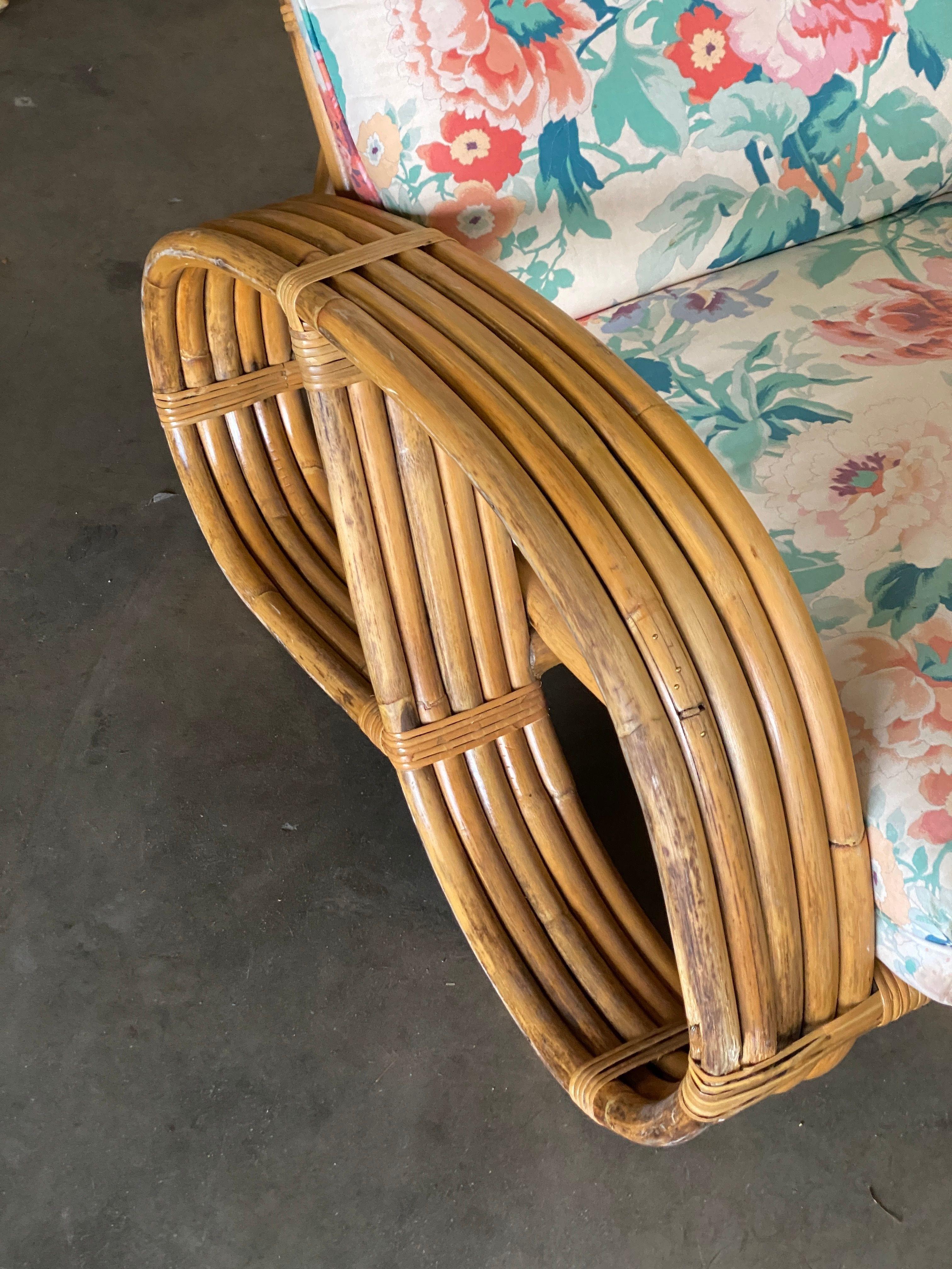 Four-strand 3/4 reverse pretzel rattan sofa and five-strand lounge chair set both feature a decorative wave detail on the base.  Reminiscent of the sofas done by Paul Frankl in the 1940s. 

Sofa: 28