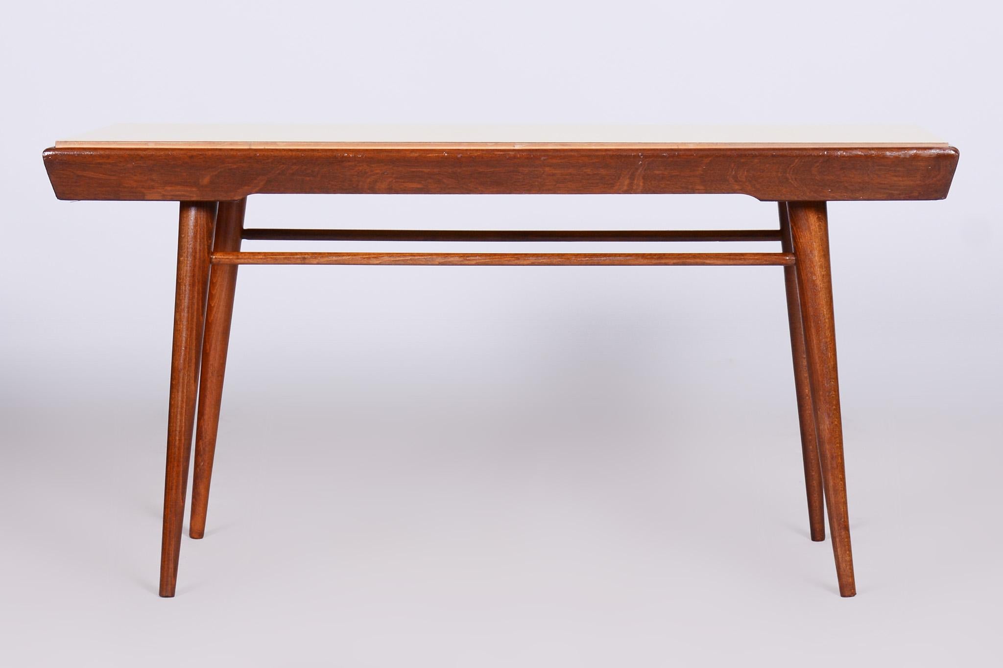 Restored midcentury coffee table with swivel top.

Period: 1950-1959
Source: Czechia
Material: Beech, Umakart.

Revived polish.
 