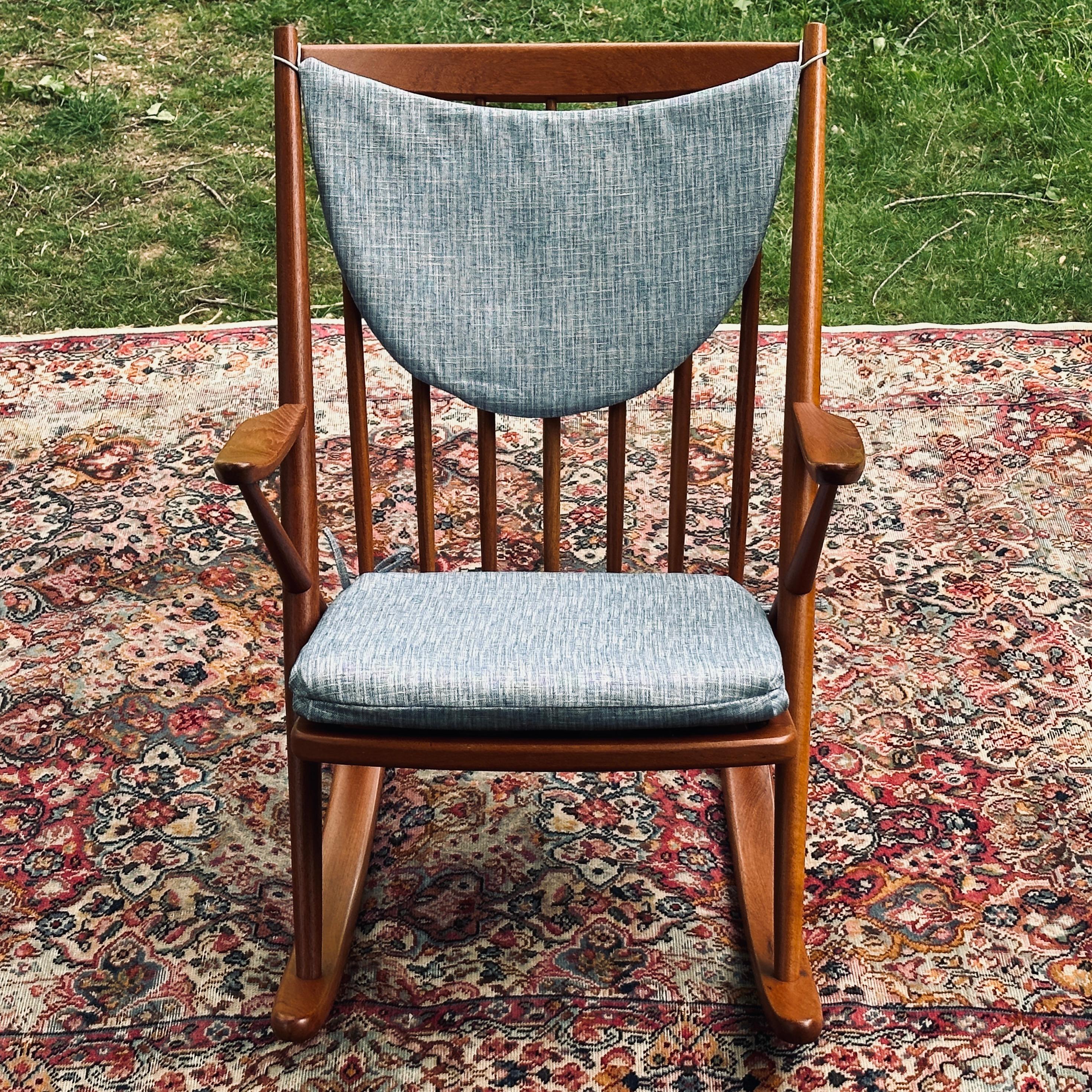 Danish modern solid teak rocker attributed to Frank Reeenskaug. Frame restored with a fresh teak oil finish and new webbing. Seat and back cushions brand new custom made by our expert upholsterers.  

DIMENSIONS
26.25ʺW × 31ʺD × 34ʺH
SEAT