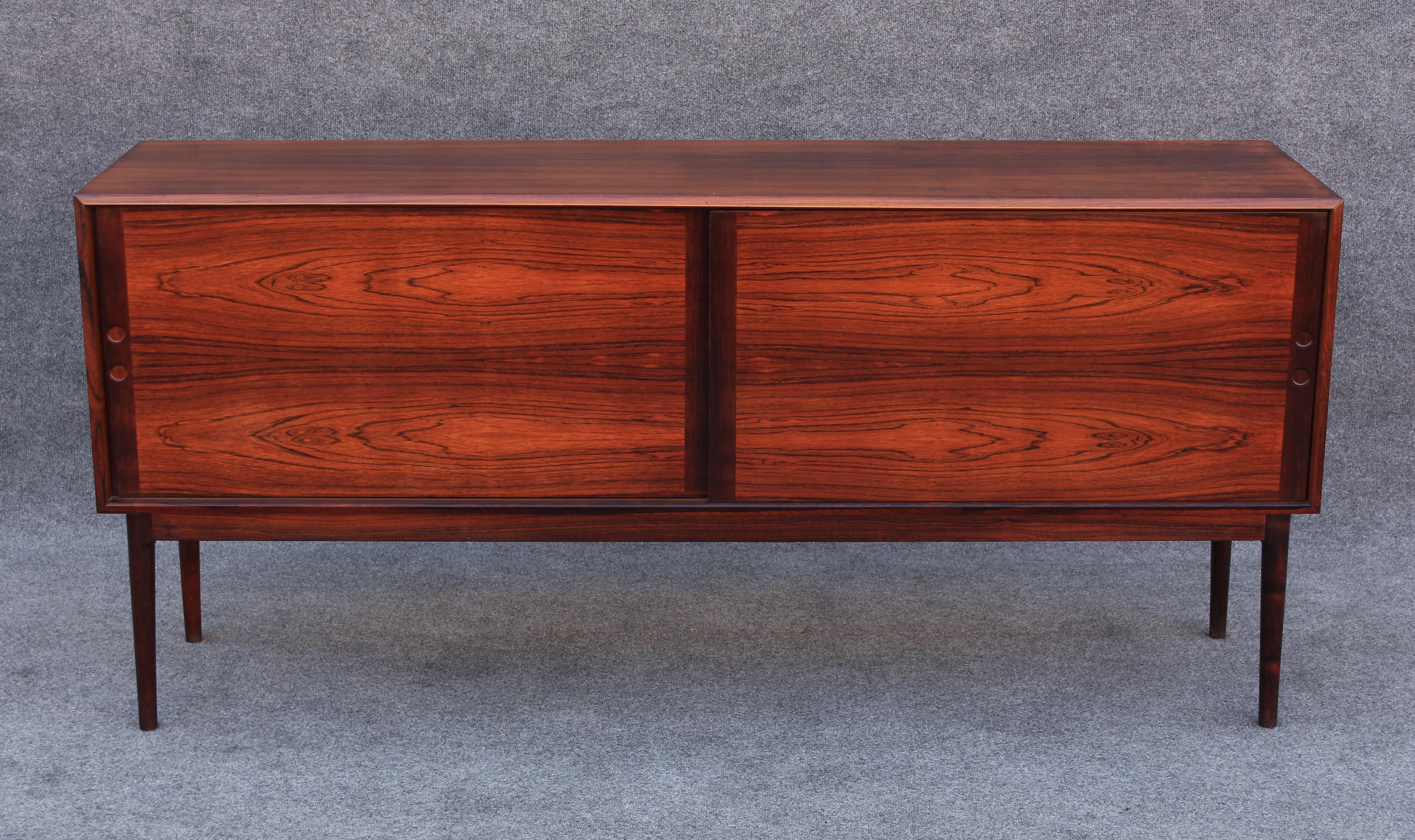 Made in Norway in the 1960s, this cabinet was made in the wake of the explosion of Danish furniture during the mid century modern movement. Brilliantly figured high contrast rosewood elevates this piece when combined with its luxurious and sleek