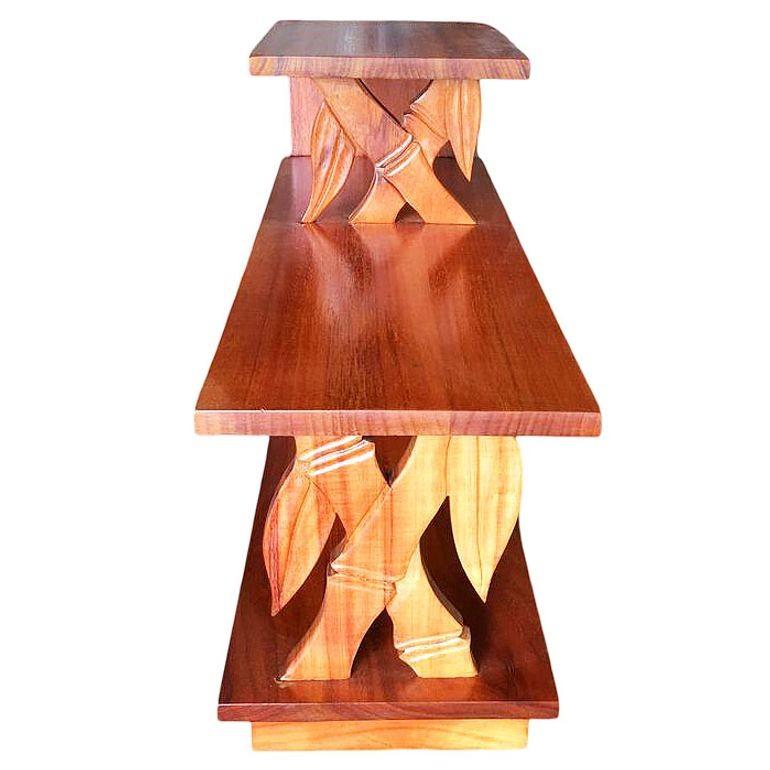This rare Hawaiian koa wood three-tier table is intricately carved to resemble bamboo, showcasing the artistry and heritage of island craftsmanship. Koa, prized for its luminous grain and scarcity, makes each piece unique. A true collector’s