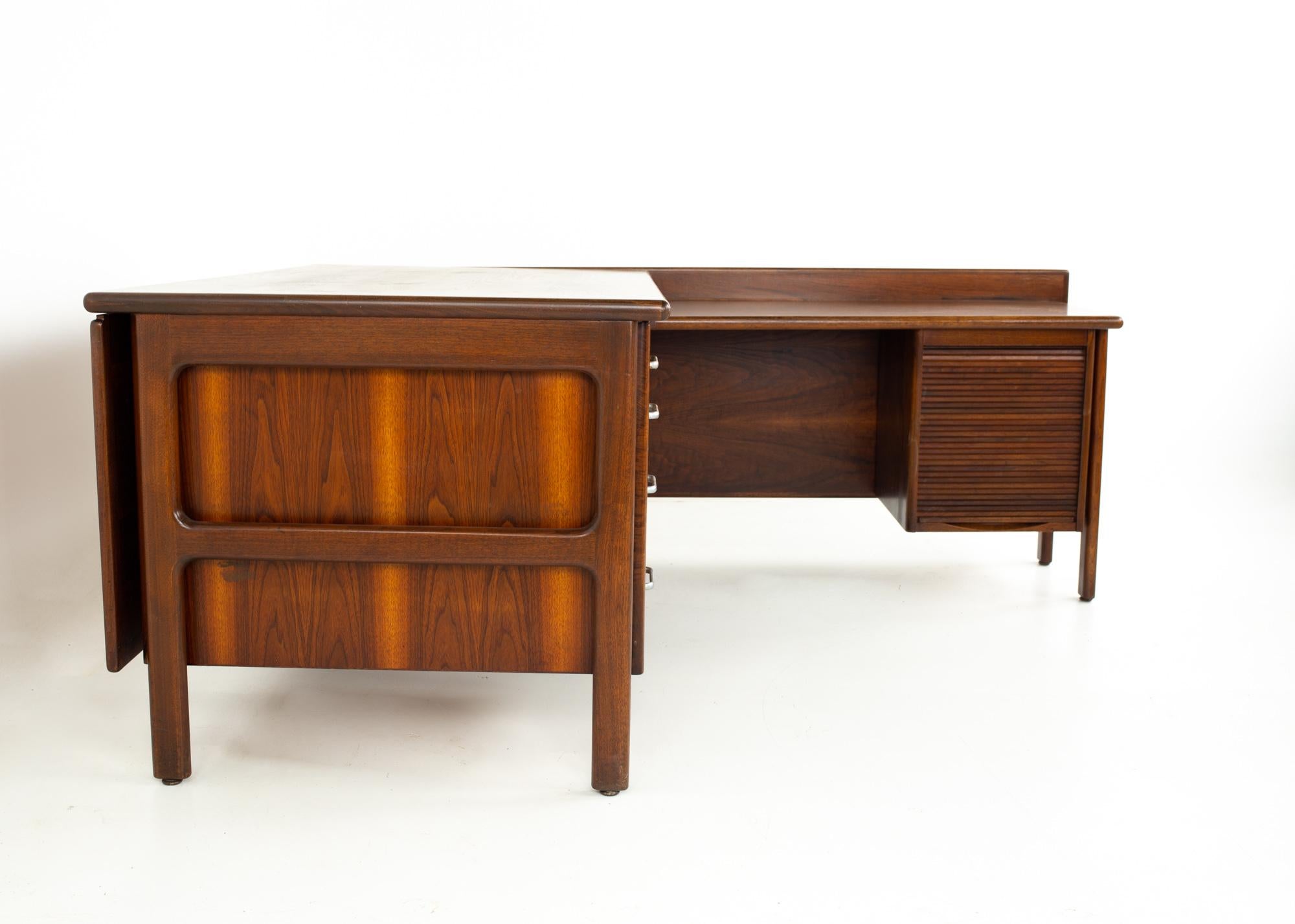 Restored mid century L-shaped desk with caned back
Desk measures: 94.5 wide x 68 deep x 28.75 high, with a chair clearance of 24.75 inches

All pieces of furniture can be had in what we call restored vintage condition. That means the piece is