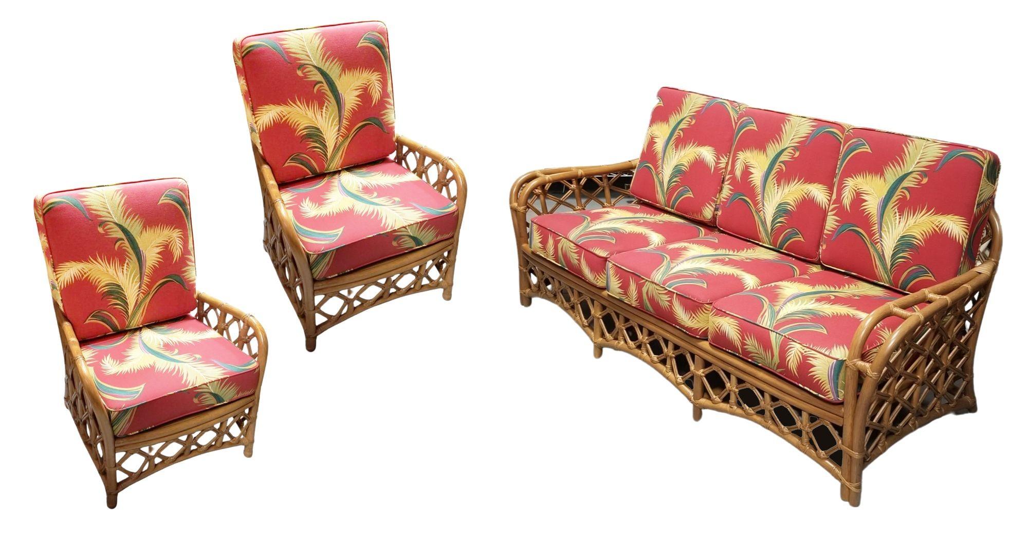 Rare restored Chinoiserie lattice rattan living room with two lounge chairs and a 3-seat sofa by Flicks Reed. Each seat features woven lattice arms with an arched woven lattice back. This style of rattan was an evolution of the stick rattan