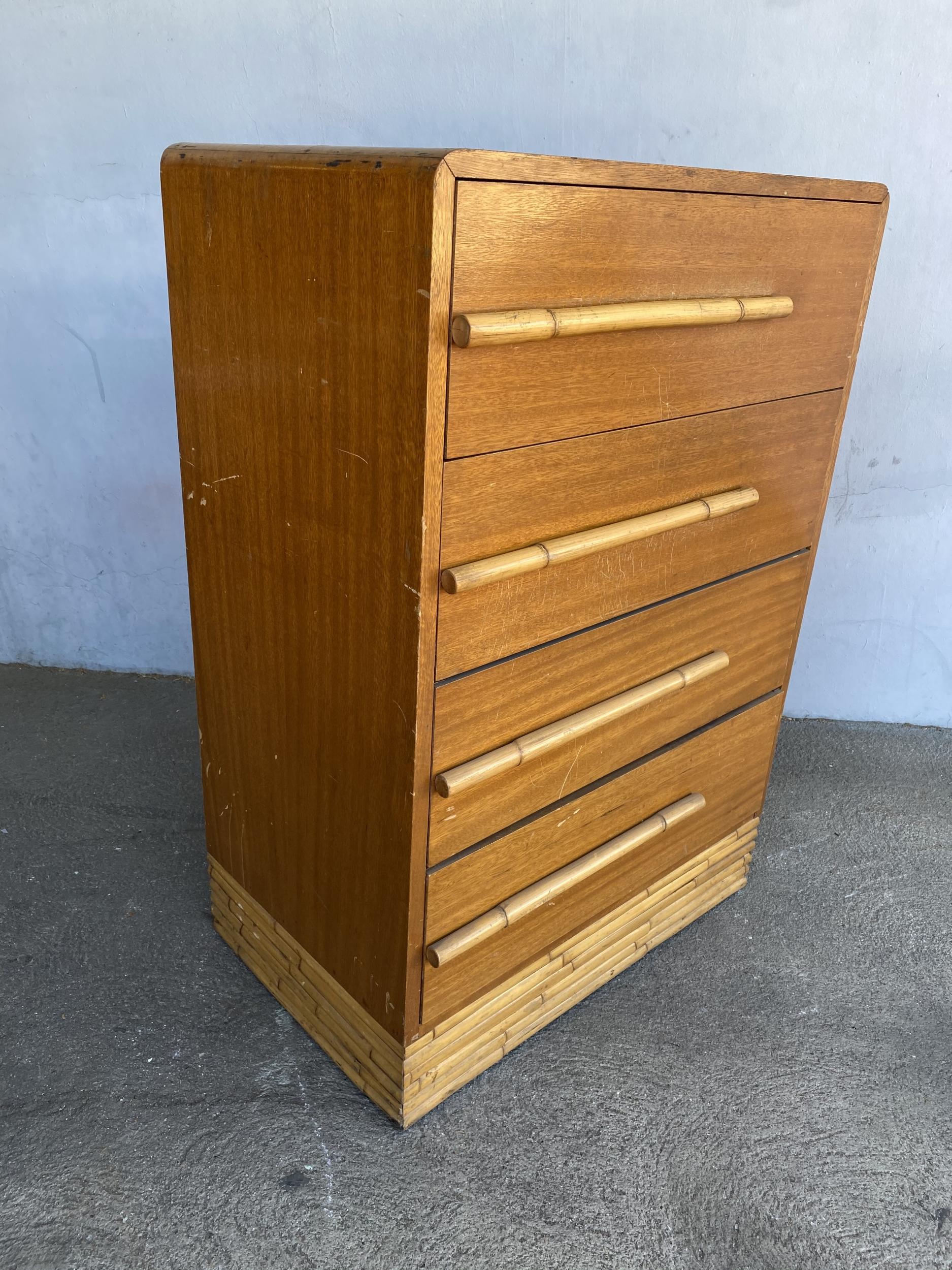 Restored midcentury mahogany highboy dresser with stacked rattan base and oversized custom made rattan drawer pulls. This highboy dresser features 4 large full-sized drawers for storage. 

Restored to new for you.

All rattan, bamboo, and wicker