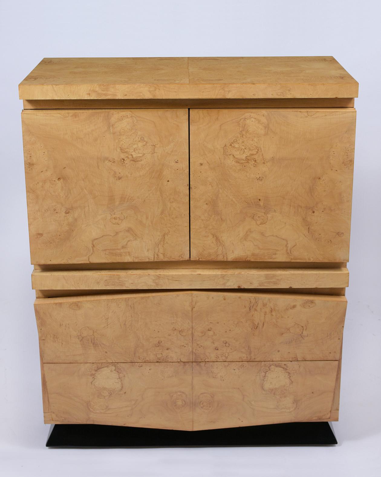 Step into the realm of mid-century design with our beautifully restored Chest of Drawers, a true testament to unmatched craftsmanship and unique style. Crafted from the finest maple wood and adorned with exotic bird-eye burled veneers, this dresser