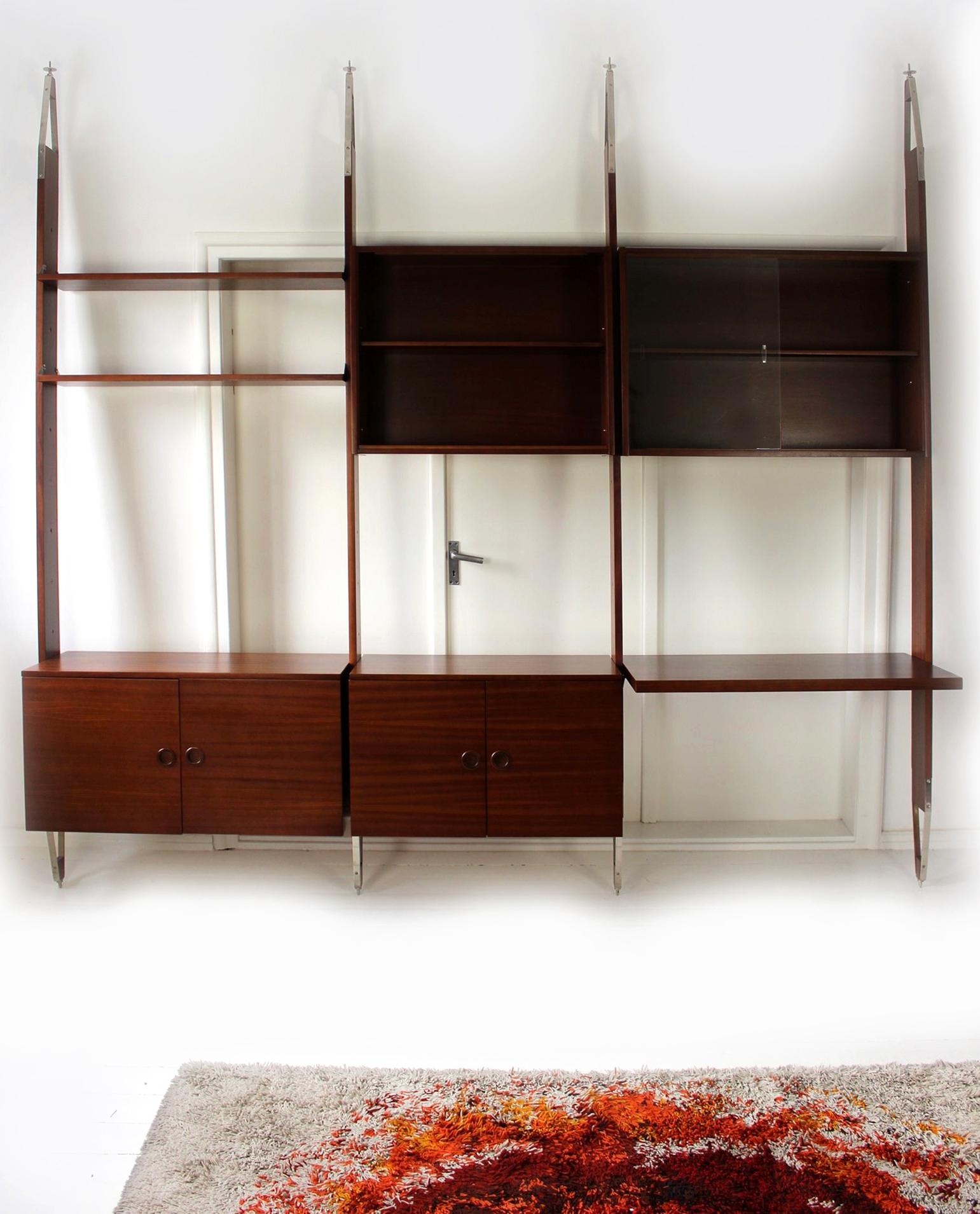 
This mahogany modular wall unit was manufactured by Jitona in the Czech Republic in 1973. It consists of 2 cabinets, 2 display cabinets, 2 shelves and a desk. The design allows for any arrangement of these elements, so we can choose the most