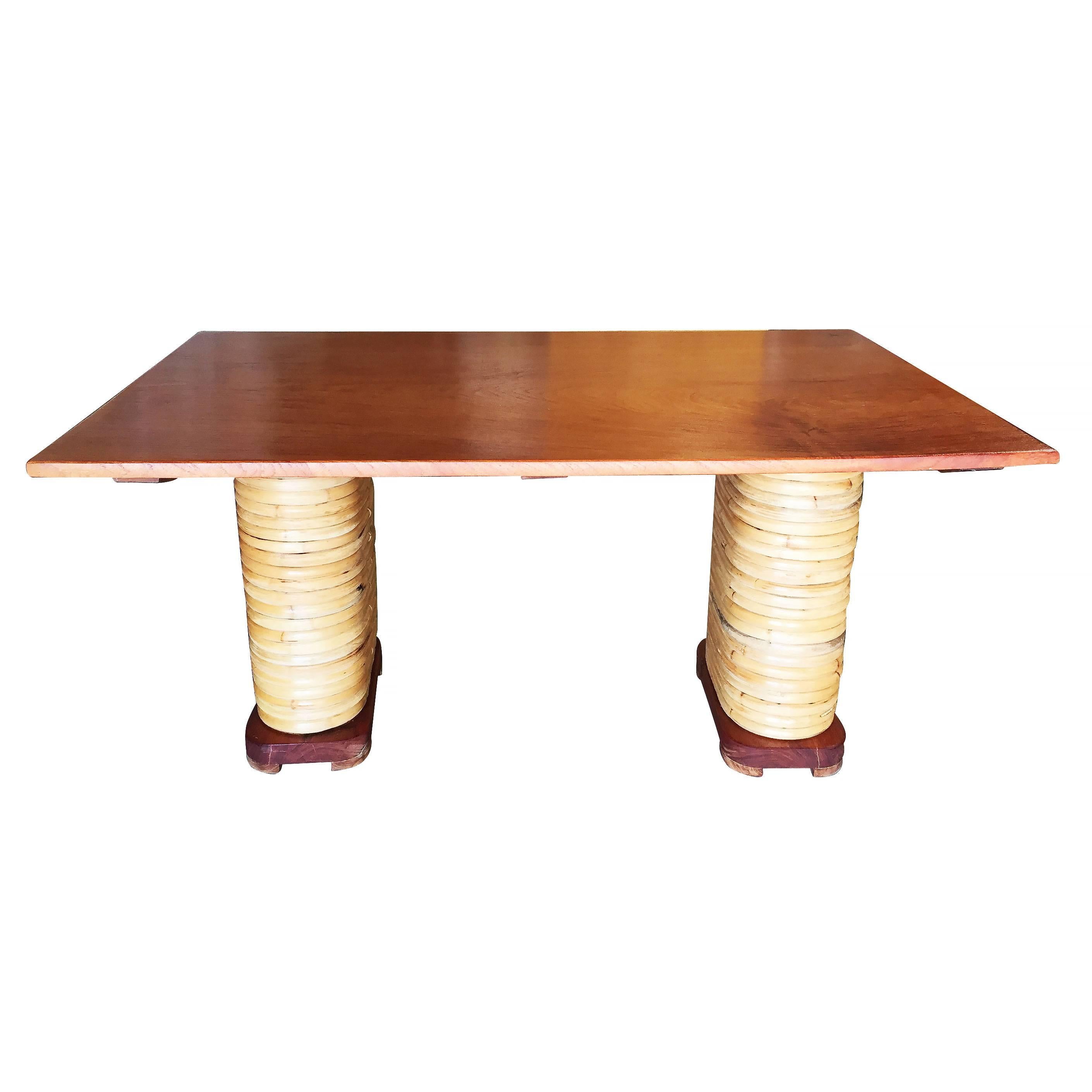 Midcentury six-person rattan dining table with stacked rattan base legs, mahogany feet, solid mahogany table.

Restored to new for you.

All rattan, bamboo and wicker furniture has been painstakingly refurbished to the highest standards with the