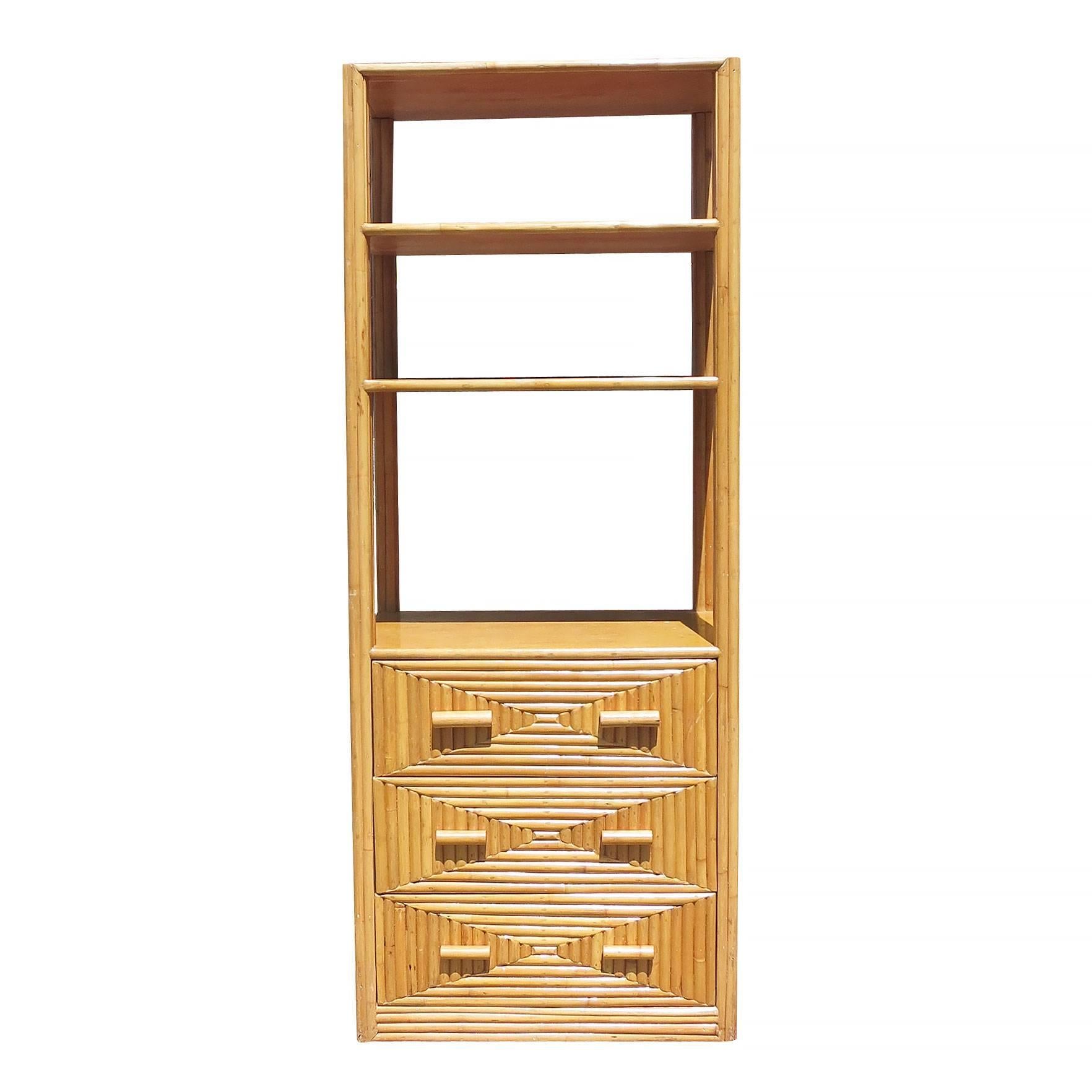 Three-tier stick rattan display cabinet with mahogany shelving and side panels, circa 1940. This large 7' tall cabinet features three fixed shelves and a bottom cabinet which has three drawers for storage. Perfect for use as a focal point in a