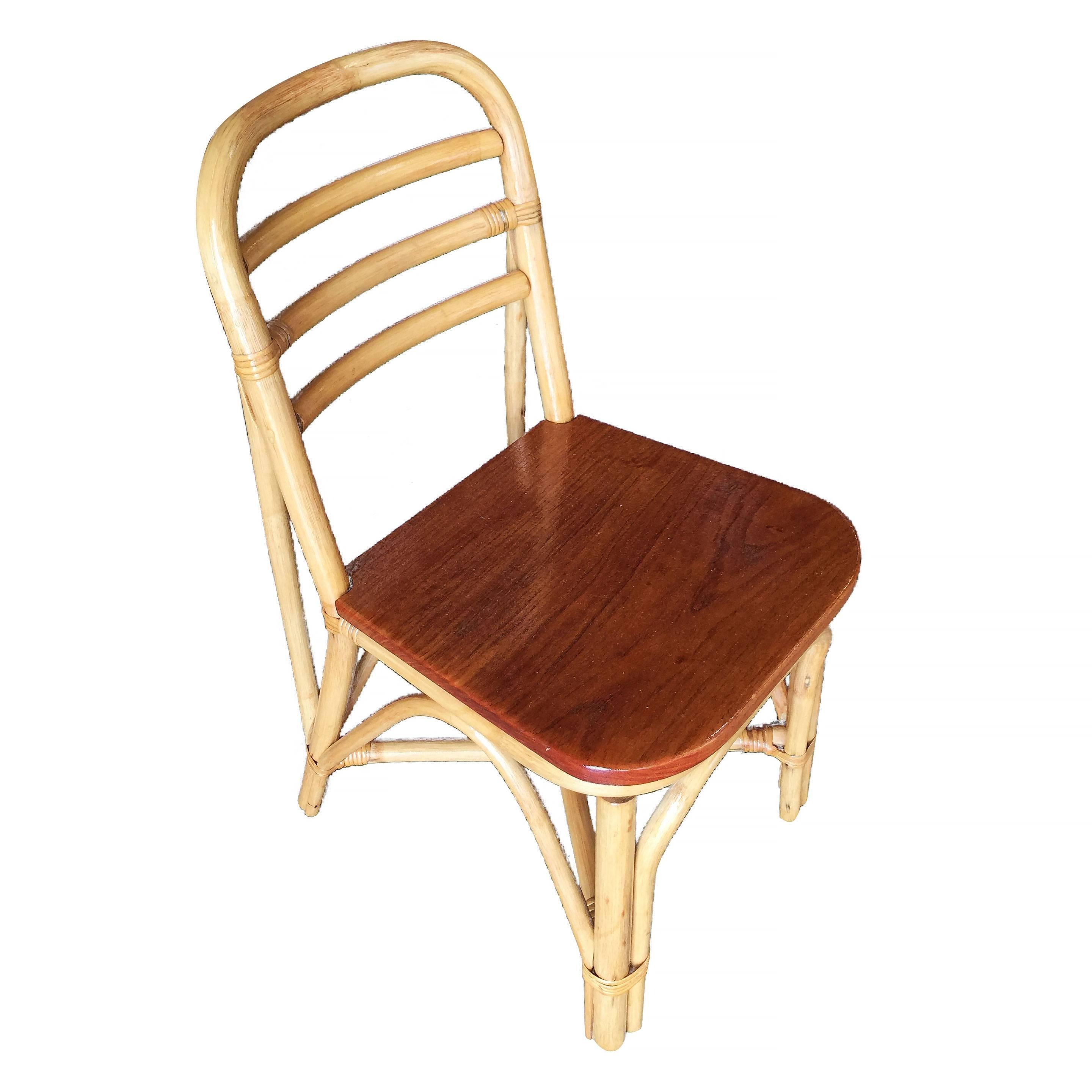 Vintage rattan dining room side chair with a mahogany seat, included is a set of six chairs. Each chair features a three strand rattan seat back with a mahogany seat.

Restored to new for you.

All rattan, bamboo and wicker furniture has been