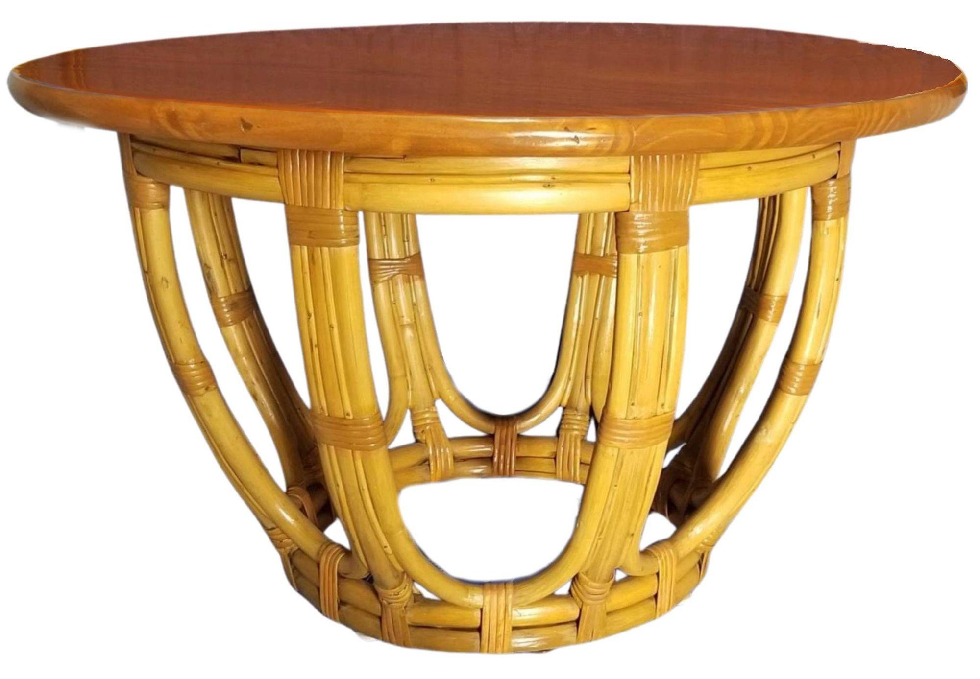 This beautifully restored Paul Frankl style rattan and round mahogany coffee table with a drum-shaped rattan base and wicker leg wrappings. The table is meticulously refinished to highlight the natural rattan’s warmth and durability. It is perfect
