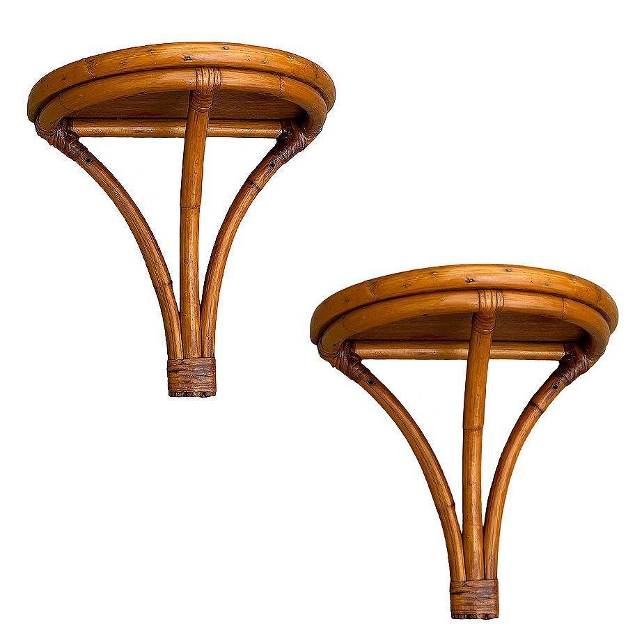 Pair of 1/2 circular rattan pedestal wall self featuring a unique V shape with a mahogany top and is completed with wicker wrappings.

Perfect for showcasing your favorite plants, books, or decorative pieces, this elegant piece combines vintage