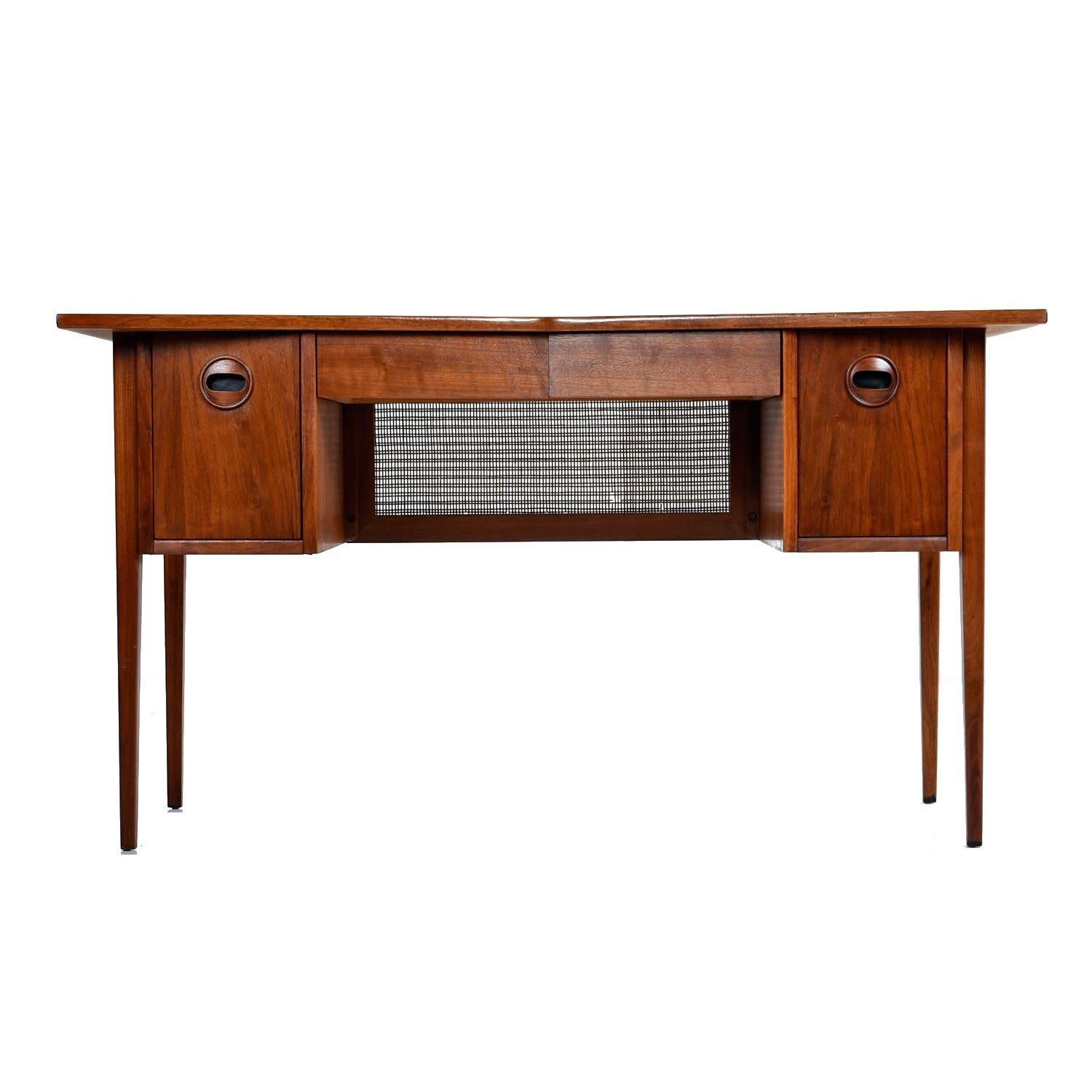 Stunning Mid-Century Modern desk with solid walnut bow tie shaped top surface. Professionally refinished to bring back it’s original glory. The decades old wood has a rich patina from age. Most unique is the bow tie shaped top surface. Practical as