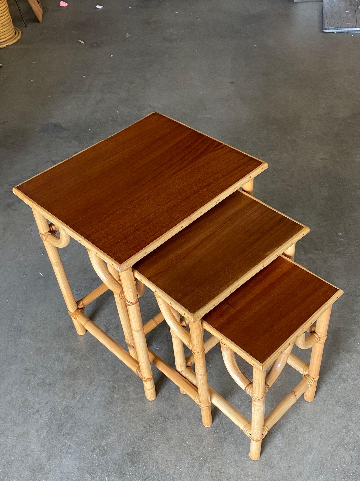 American Restored Mid-Century Set of 3 Rattan Nesting Side Tables with Mahogany Top For Sale