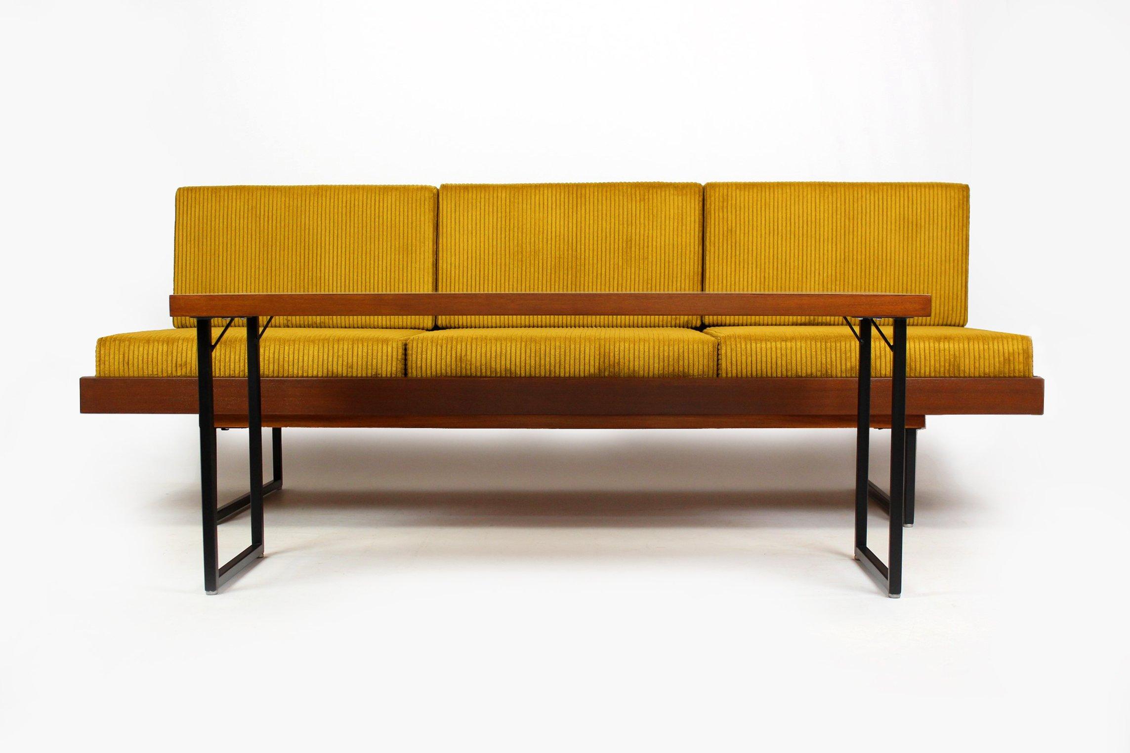 Mid-century sofa daybed with coffee table, manufactured in the 1960s by Interier Praha in Czechoslovakia. Made of mahogany veneered wood, set on metal legs.

The sofa has been restored, lacquered woodwork and metal elements, brand new pillows