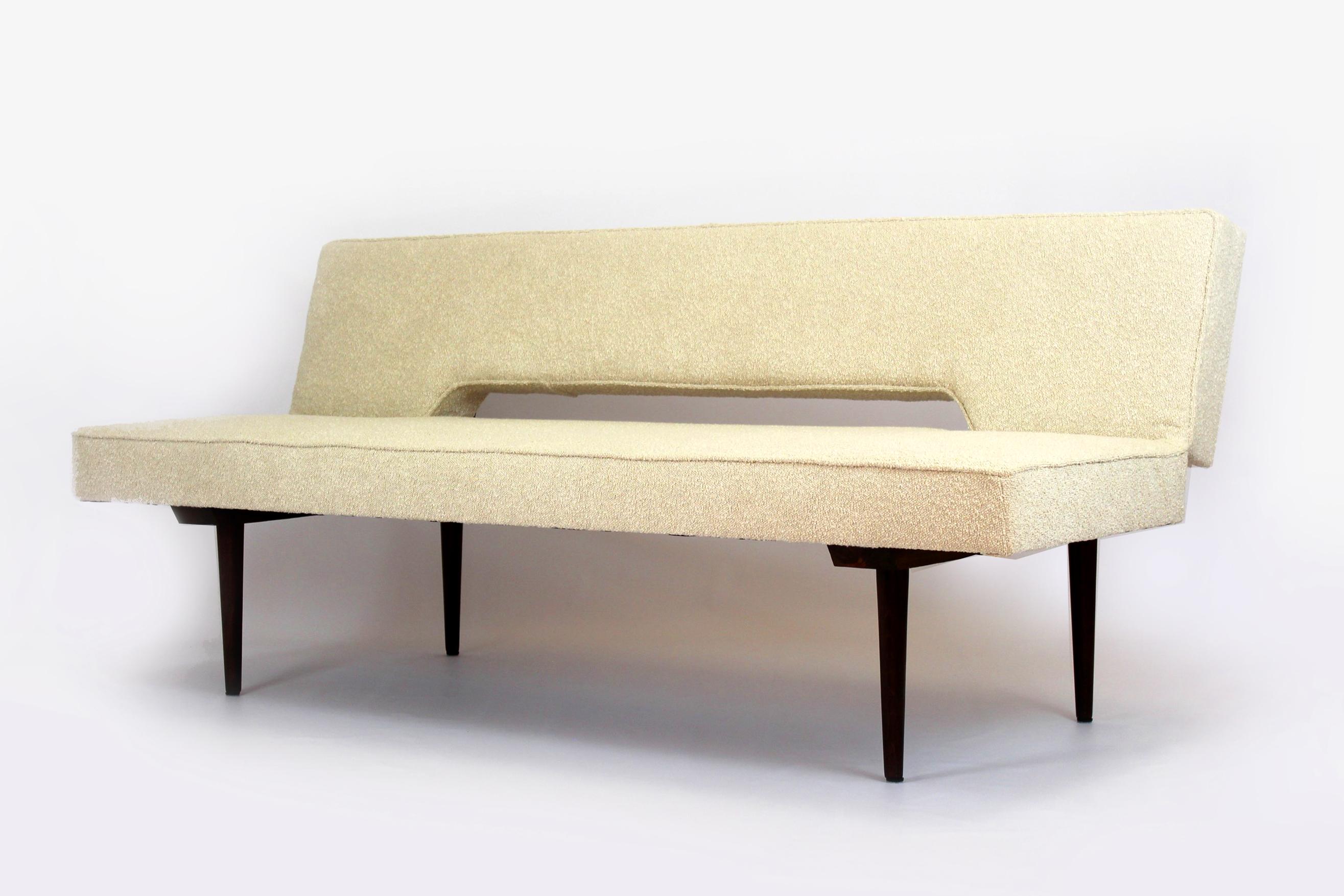 This Mid-Century Modern sofa was designed by Miroslav Navratil and produced in the 1960s in Czechoslovakia. The couch simply converts into a bed: 183x88cm. The sofa has been restored, upholstered in high-quality boucle fabric. Lacquered woodwork in