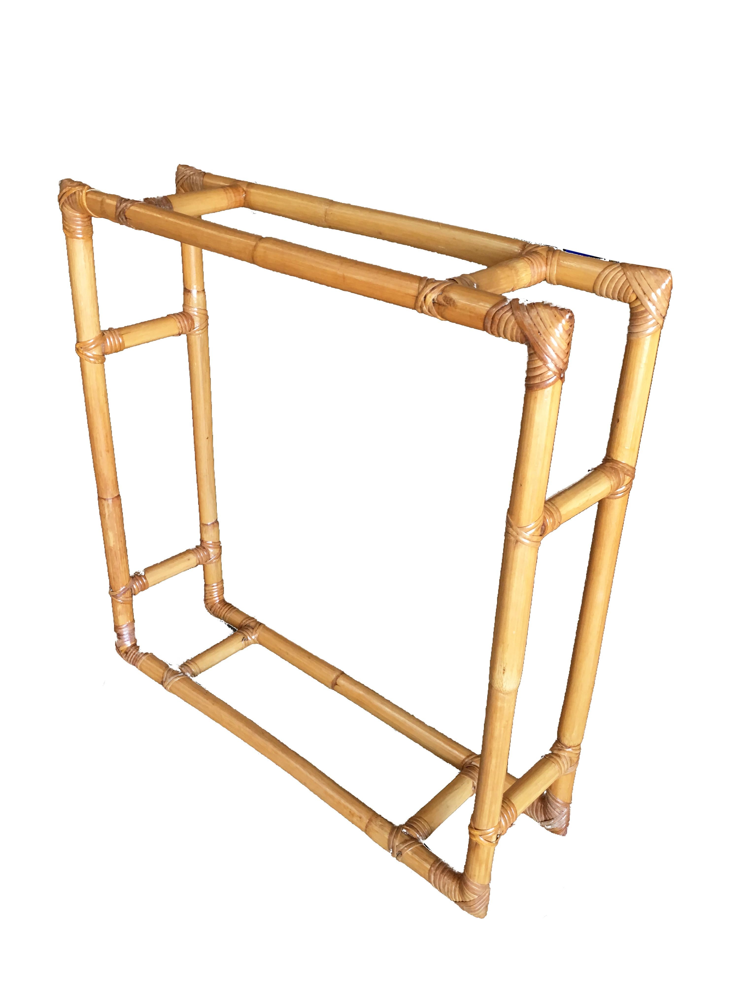 Square rattan wall shelf, circa 1950. This rare rattan wall shelf features a unique 2-strand rattan frame made with two cross sections that hold two glass shelves.

Professionally restored in 2019

All rattan, bamboo and wicker furniture has