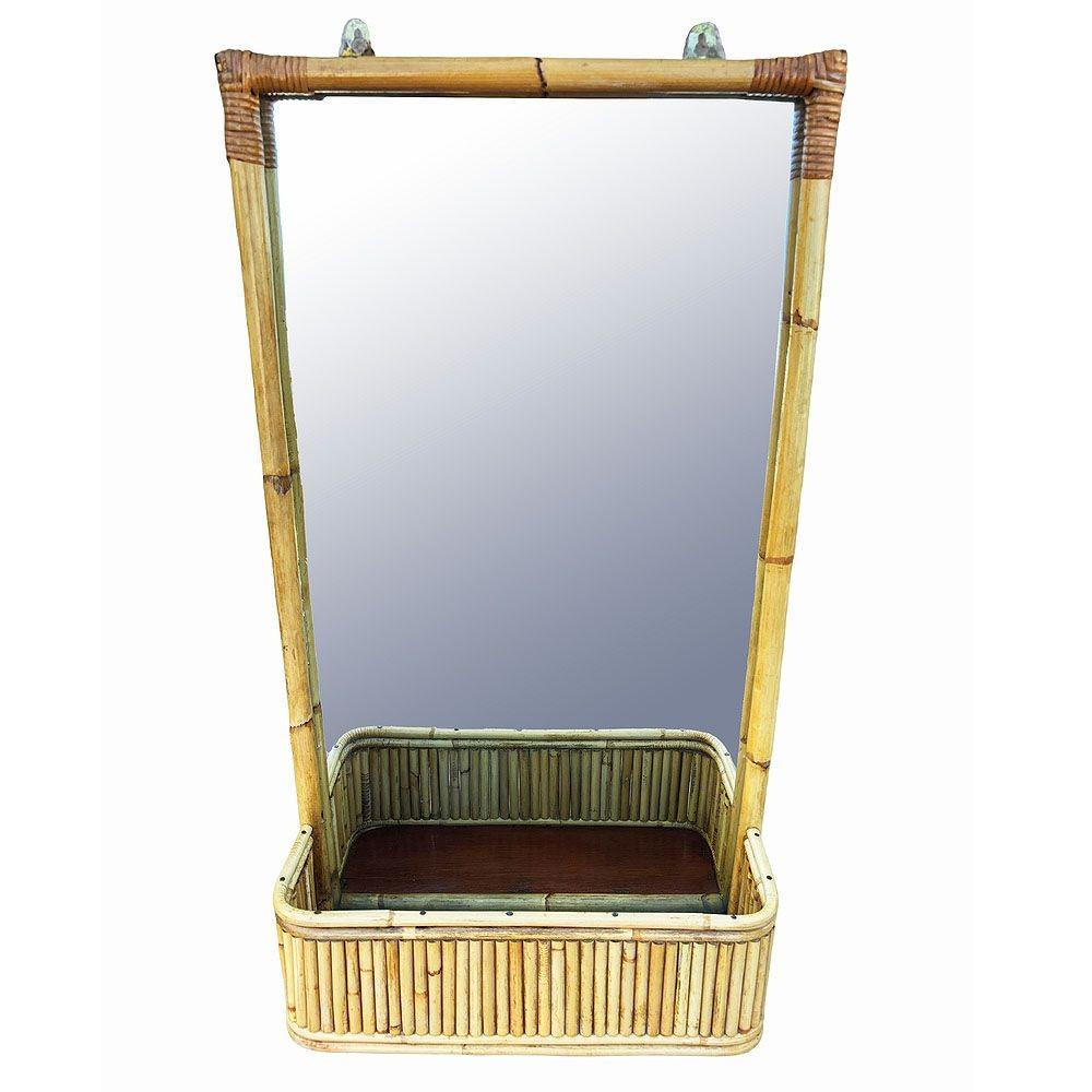 Elevate your decor with this restored Mid-century Paul Frankl inspired rattan wall mirror featuring a tray shelf that can be used as a planter. The natural rattan poles are joined together with fancy wicker wrappings along the corners and a stacked