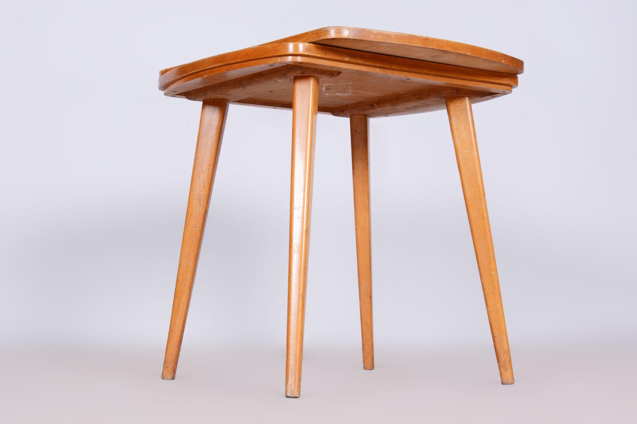 Restored MidCentury Coffee Table.

Source: Czechia 
Period: 1950-1959
Material: Beech, Umakart
Revived Polish.

The table top is double and rotatable.

This item features classic Mid-Century Modern (MCM) design elements. Elements of MCM interior
