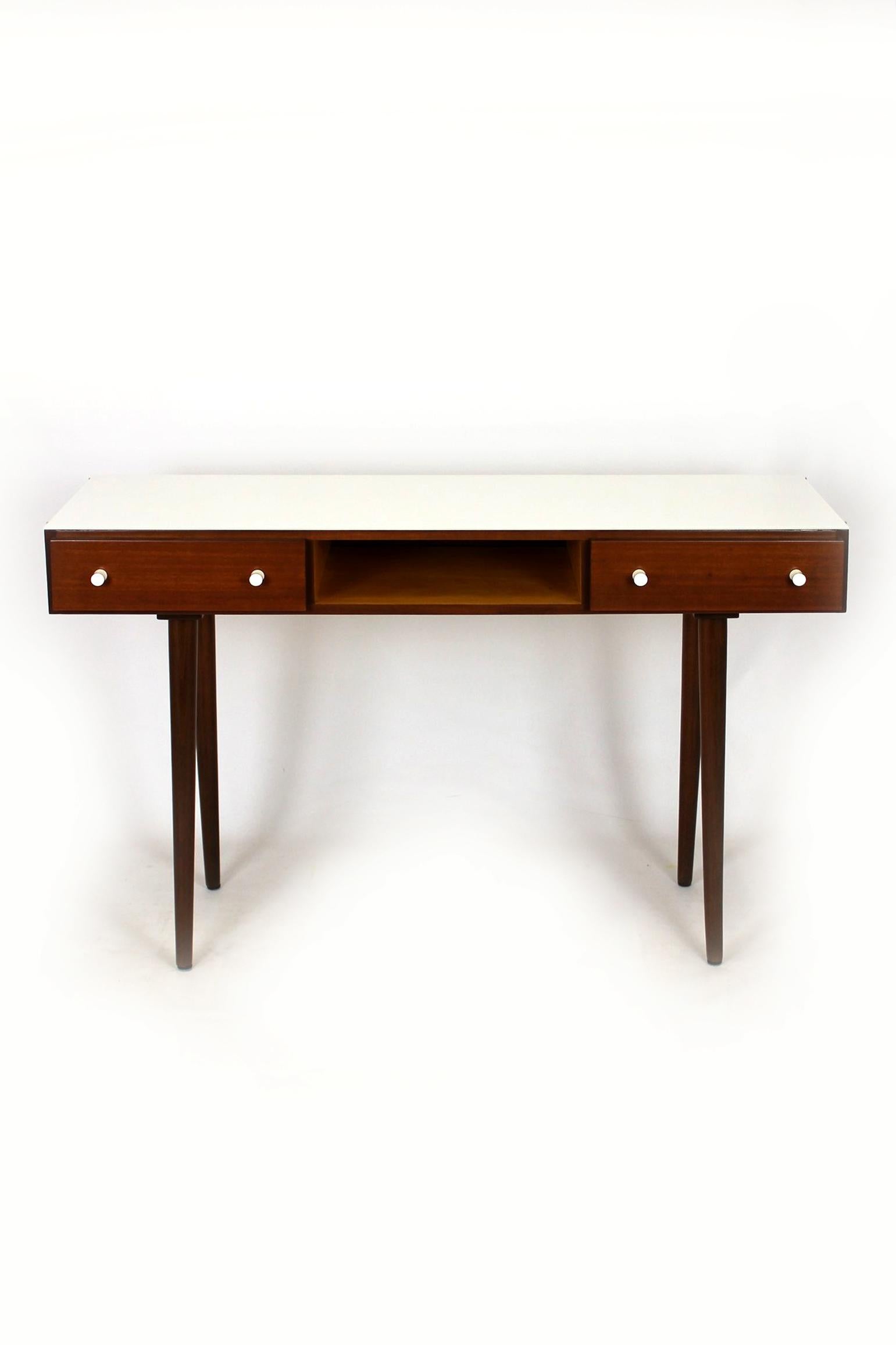 Mid-century writing desk which can also be used as a console table. Manufactured by UP Zavody Bučovice in former Czechoslovakia during the 1960s. Features two drawers and white glass on the top.
The desk has been completely renovated, the glass has
