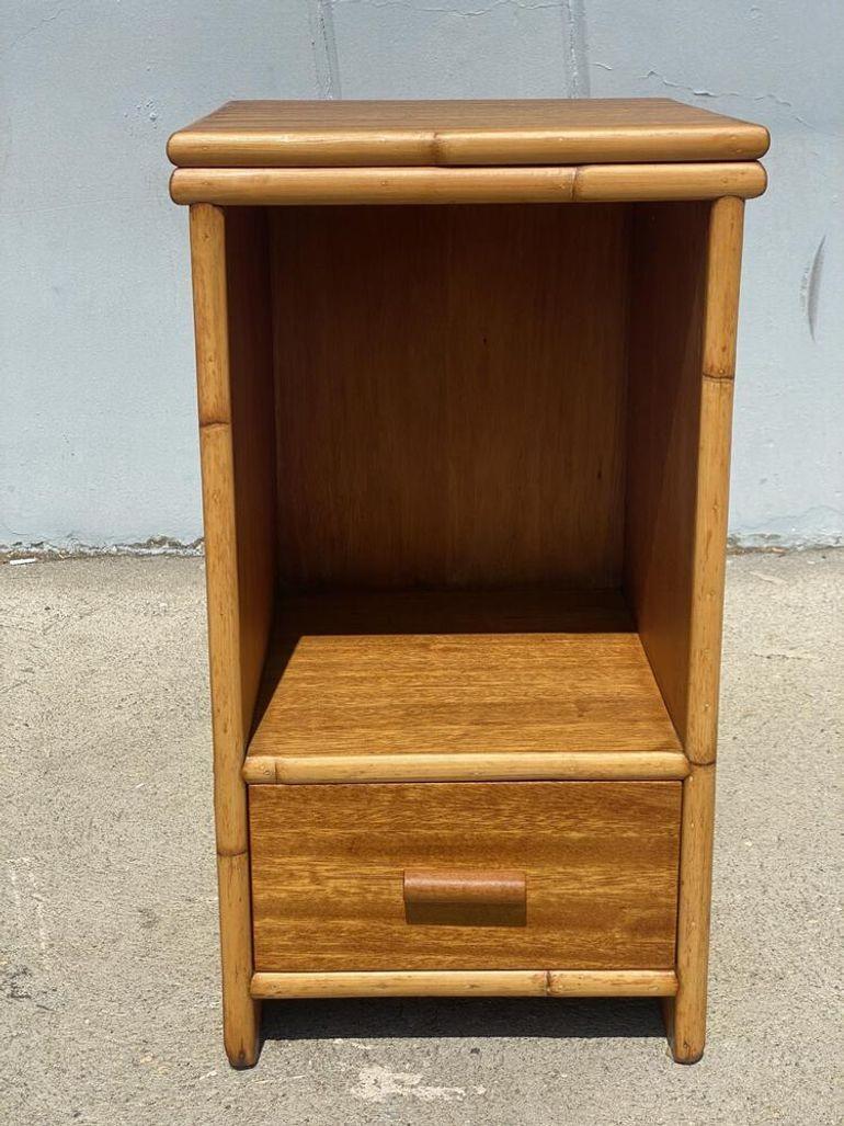 Restored post-war Koa Wood bedside table decorated with Rattan accents with single drawer and cubby space.
1940, United States
We only purchase and sell only the best and finest rattan furniture made by the best and most well-known American