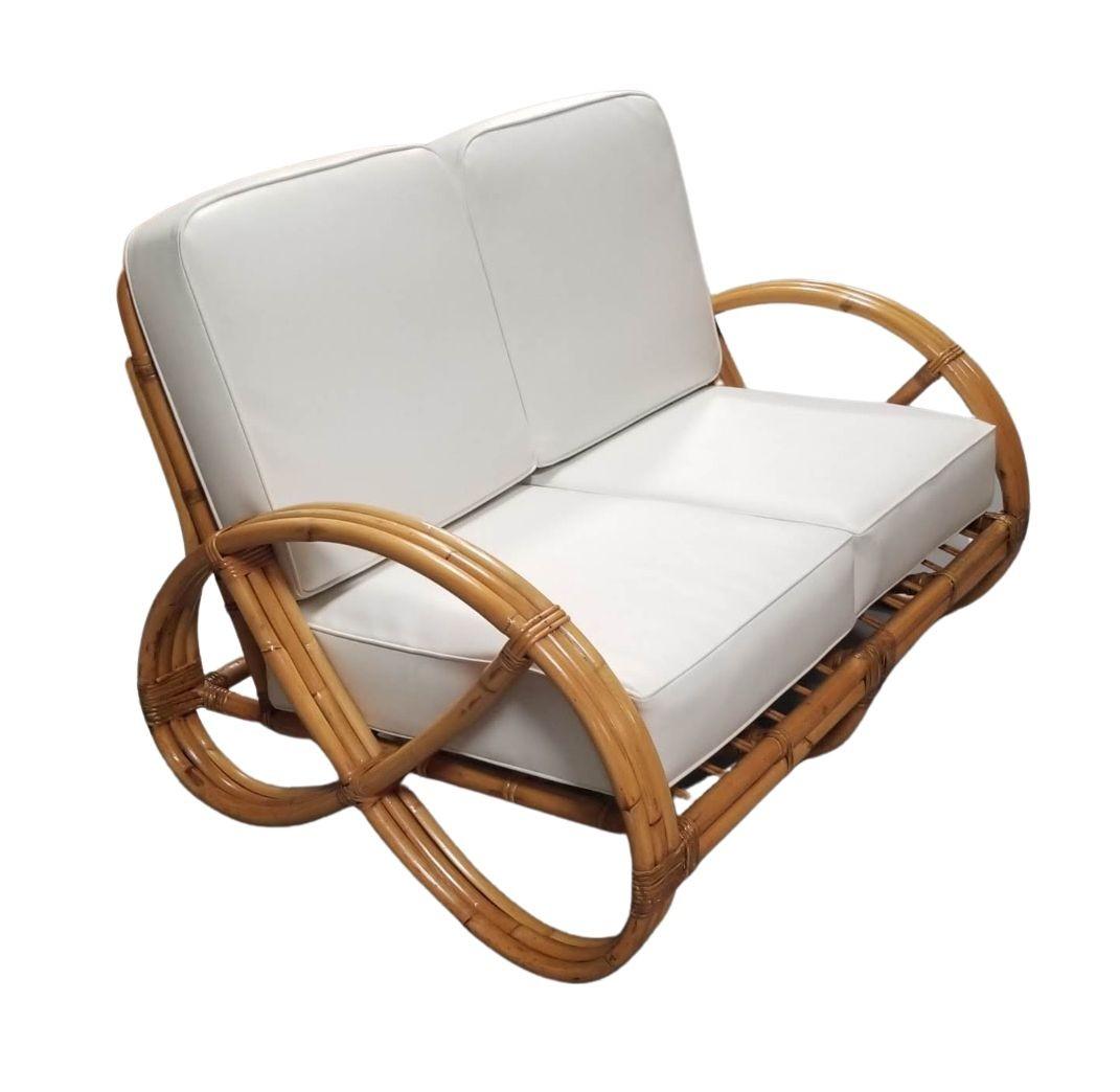 Restored mid-century era round full pretzel two-seat settee Loveseat with a three-strand round pretzel armrest.

1950, United States

We only purchase and sell only the best and finest rattan furniture made by the best and most well-known