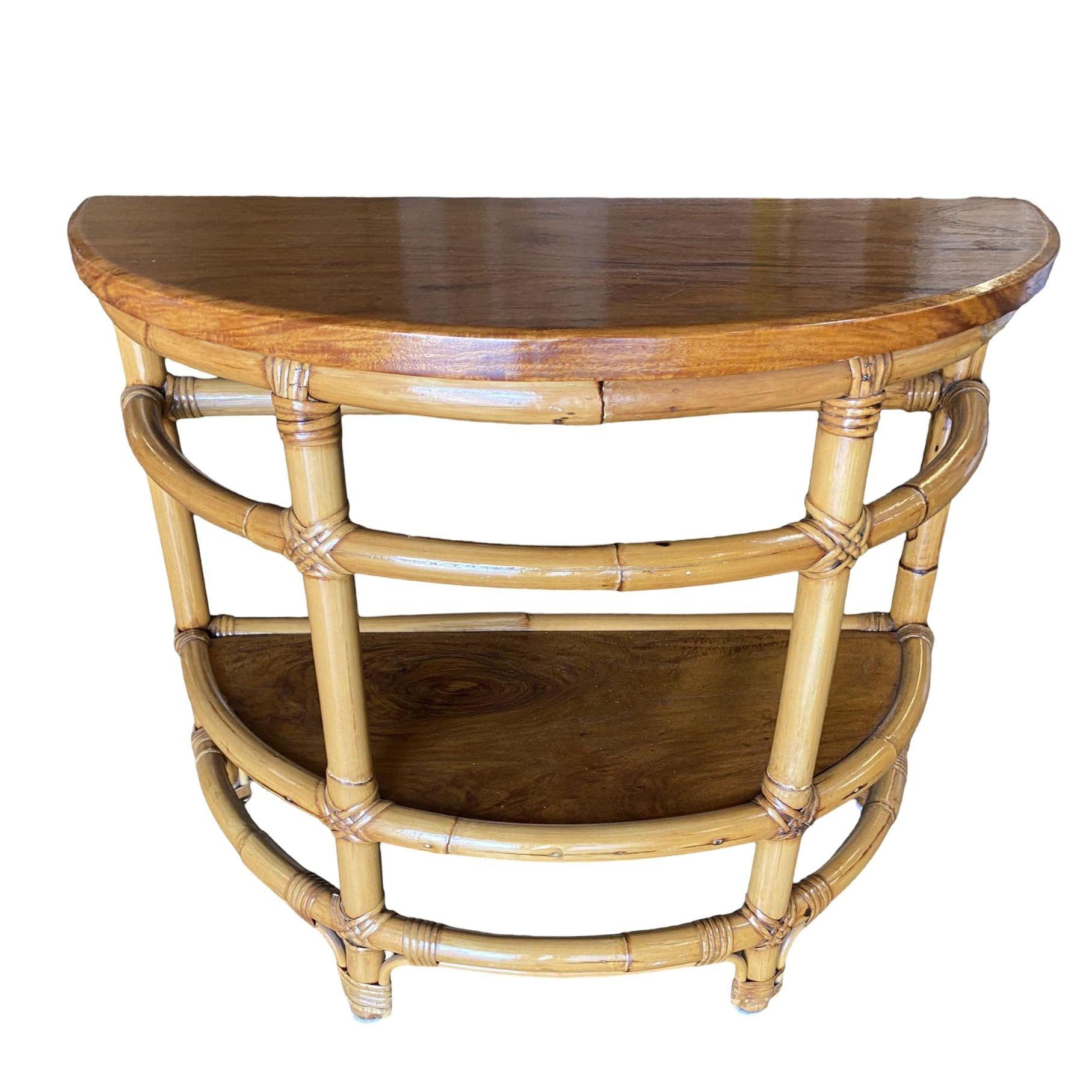 Vintage 1940s two-tier rattan side table featuring stylized single-strand legs, ladder sides, and beautiful half-round mahogany tops.

1950, United States

We only purchase and sell only the best and finest rattan furniture made by the best and