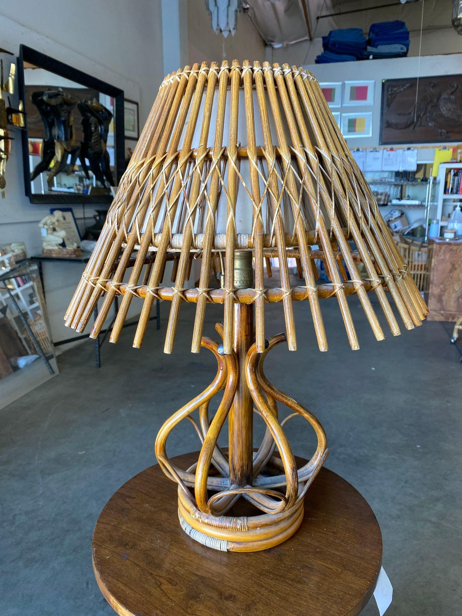 Modernist stacked stick rattan table lamp with outward stick rattan fan shade.

Lamp: 20