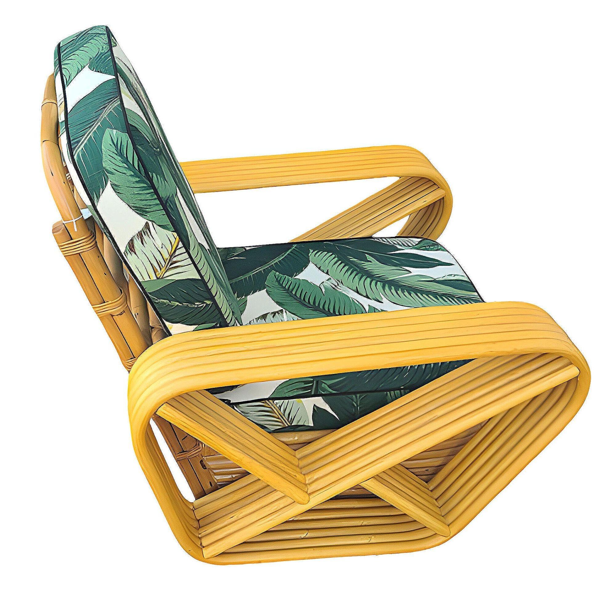 Designed in the manner of Paul Frankl, this six-strand rattan lounge chair features square pretzel arms and the classic stacked rattan base with 