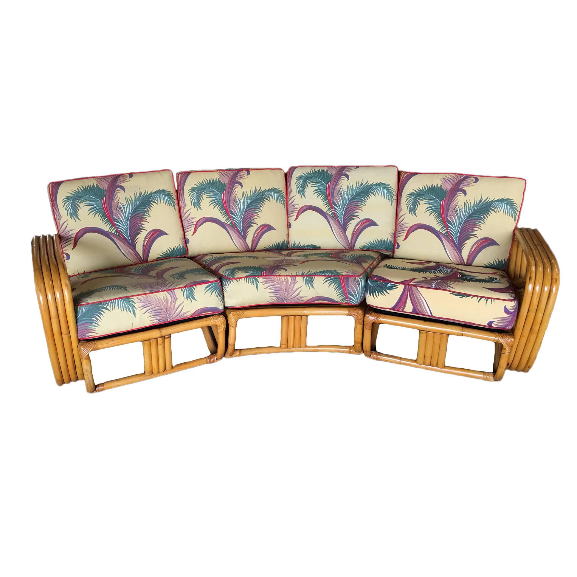 Four strand square pretzel corner rattan sectional sofa designed in the manner of Paul Frankl. This sofa features a bent rattan base with four strand square pretzel arms and is divided into a three sectionals, two end pieces that each fit one person