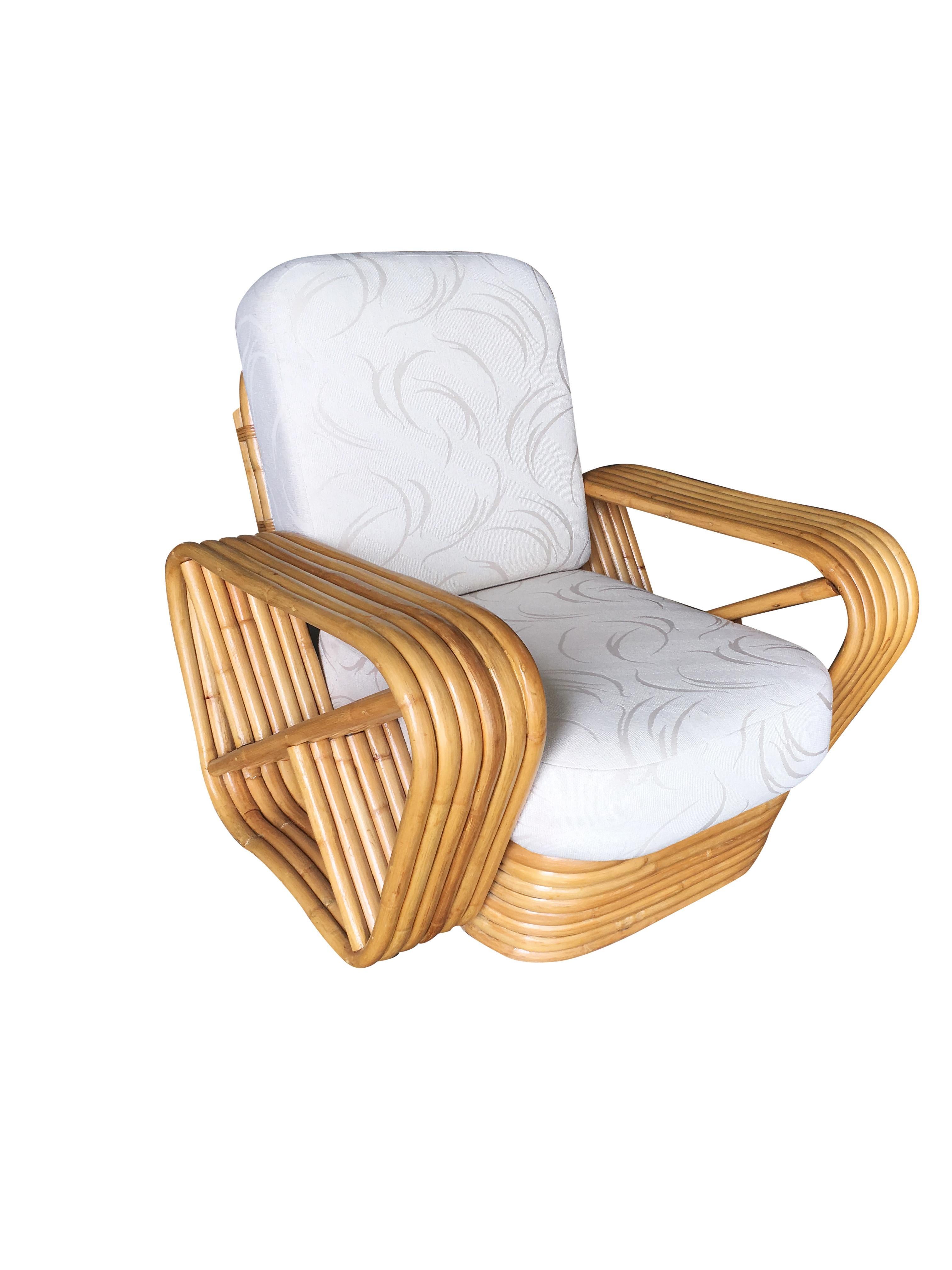 Paul Frankl style Rattan living-room set including a matching sectional sofa and lounge chair. Both feature the famous six strand square pretzel side arms and stacked rattan base originally designed by Paul Frankl. The seats are covered in palm leaf