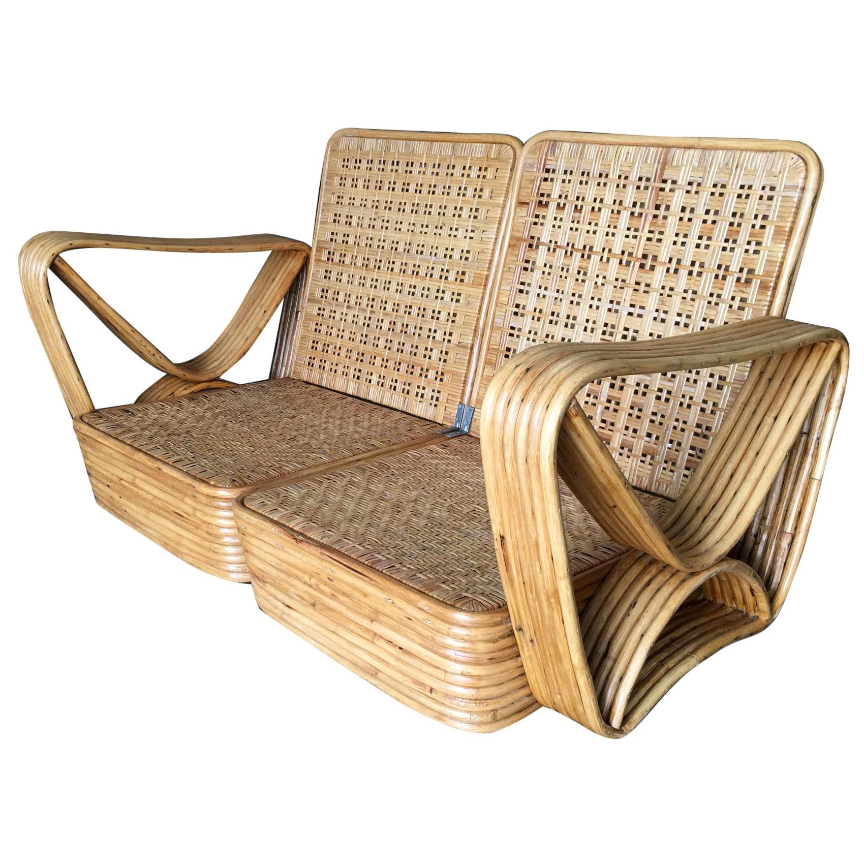 Paul Frankl style stick rattan living room set including a matching three-seat sectional sofa, Ottoman and pair of end tables. The sofa features the famous six strand square pretzel side arms and stacked rattan base with matching stacked rattan side