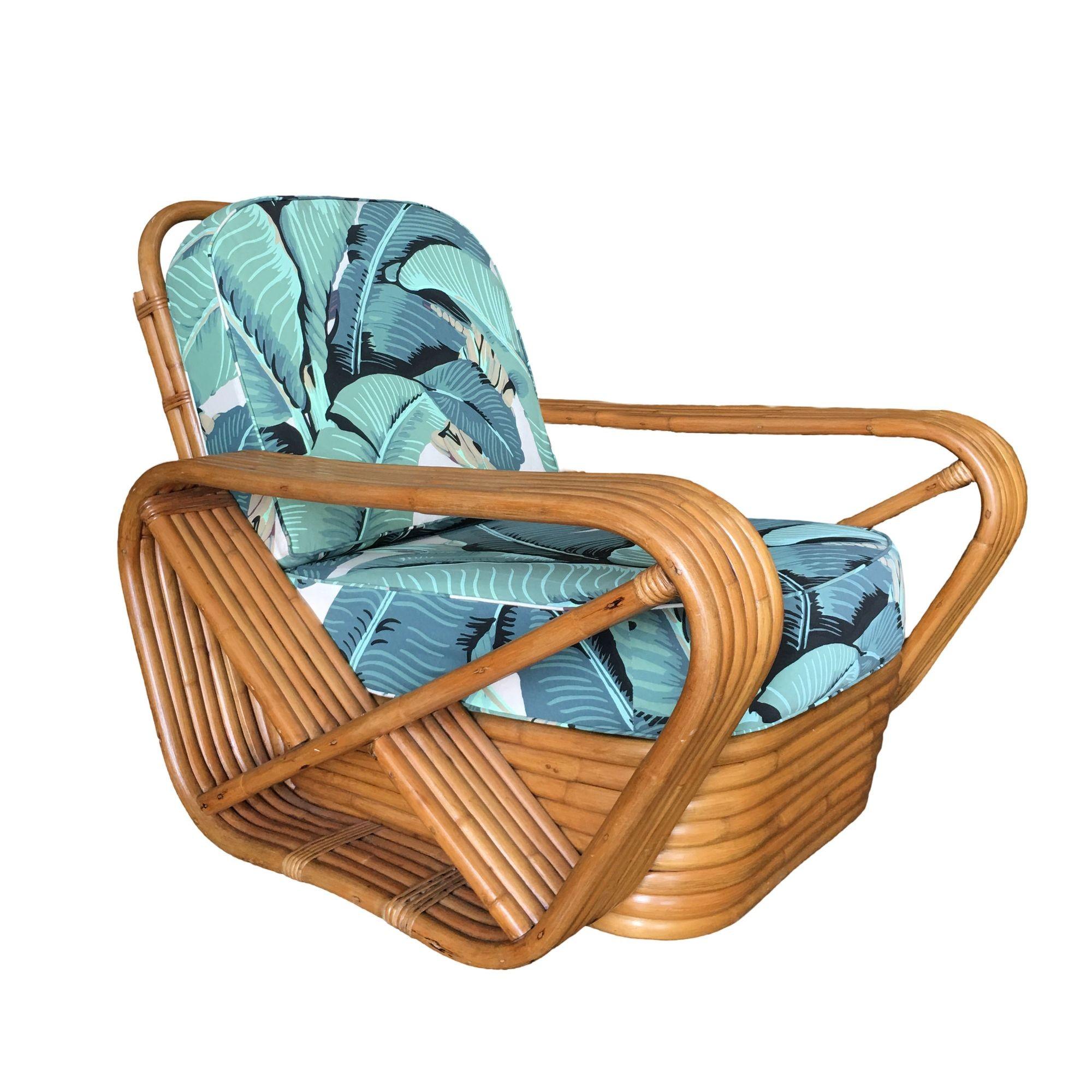 Designed in the manner of Paul Frankl this six-strand rattan lounge chair features square pretzel arms and the classic stacked rattan base with 