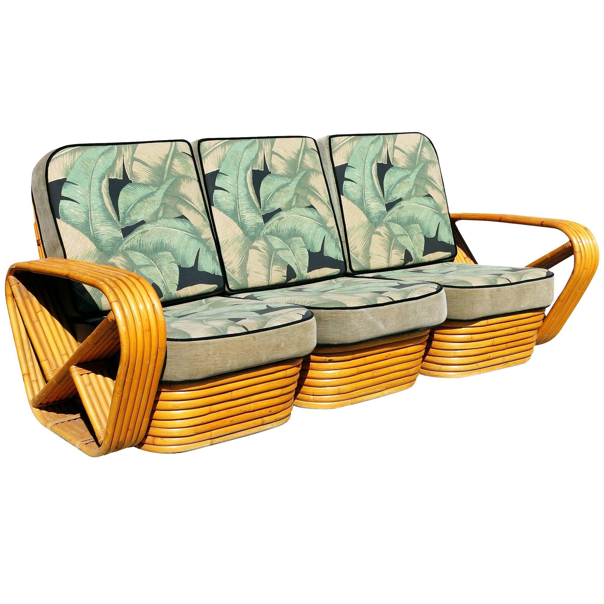 Six-strand square Pretzel style, three-seat sectional sofa. This sofa set of two features the famous six strand square pretzel side arms and stacked rattan base. The seats are covered in palm leaf patterned barkcloth cushions. 

Measures:
Sofa: