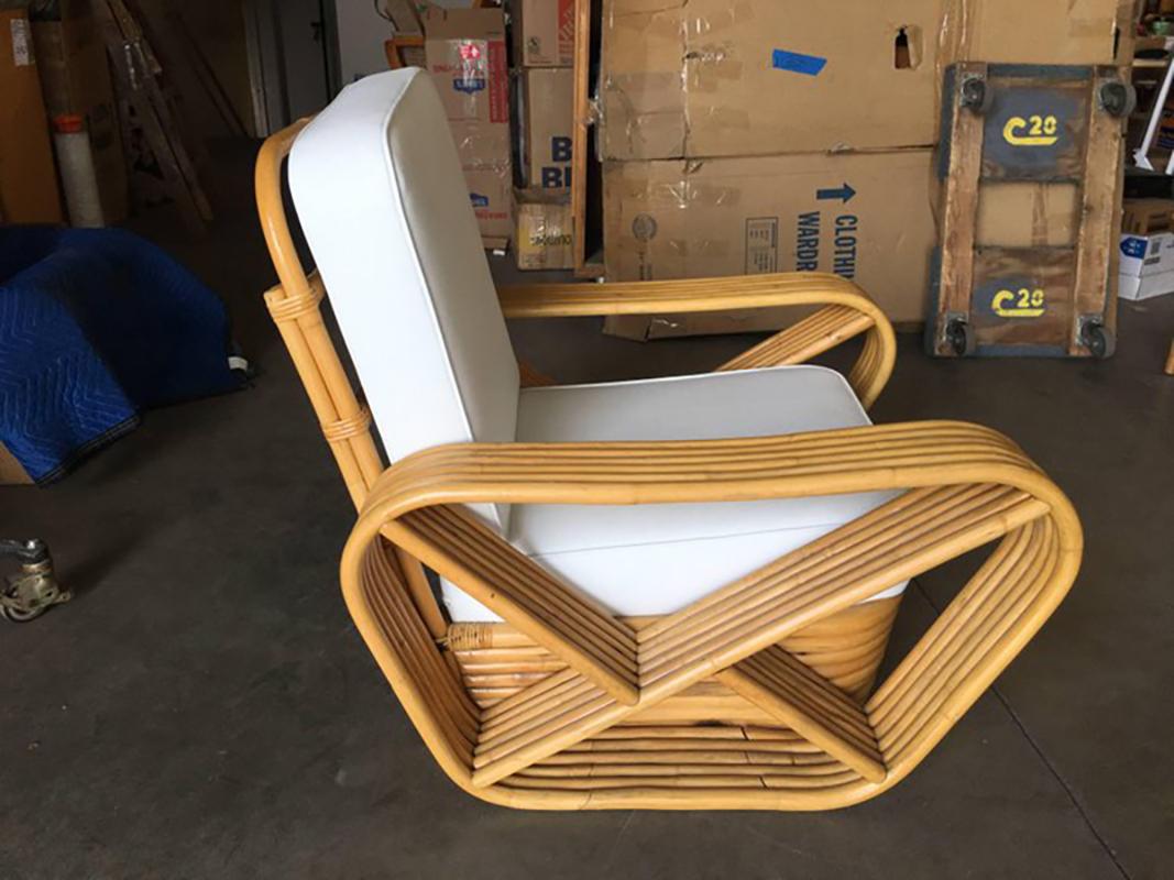 Six strand square pretzel arm rattan occasional chairs with stacked base in the manner of Paul Frankl Pair. 


New Custom or Original Cushions in White Naugahyde or C.O.M. (Costumers Own Material) are included in the price. Simply supply the fabric