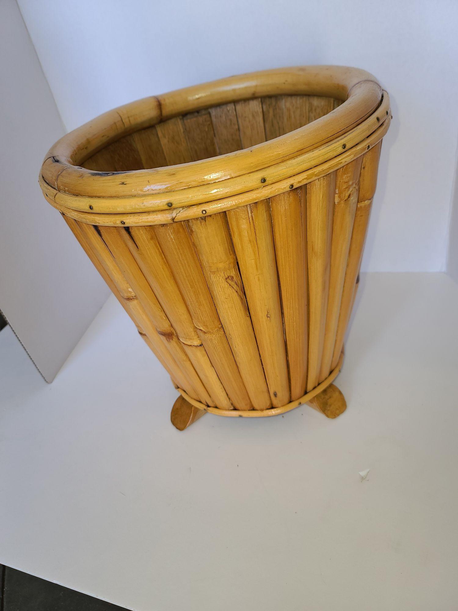 Original Paul Frankl rattan wastebasket featuring a stacked rattan basket fixed to a mahogany base. This basket comes from a Paul Frankl house in Encino California. 

We only purchase and sell only the best and finest rattan furniture made by the