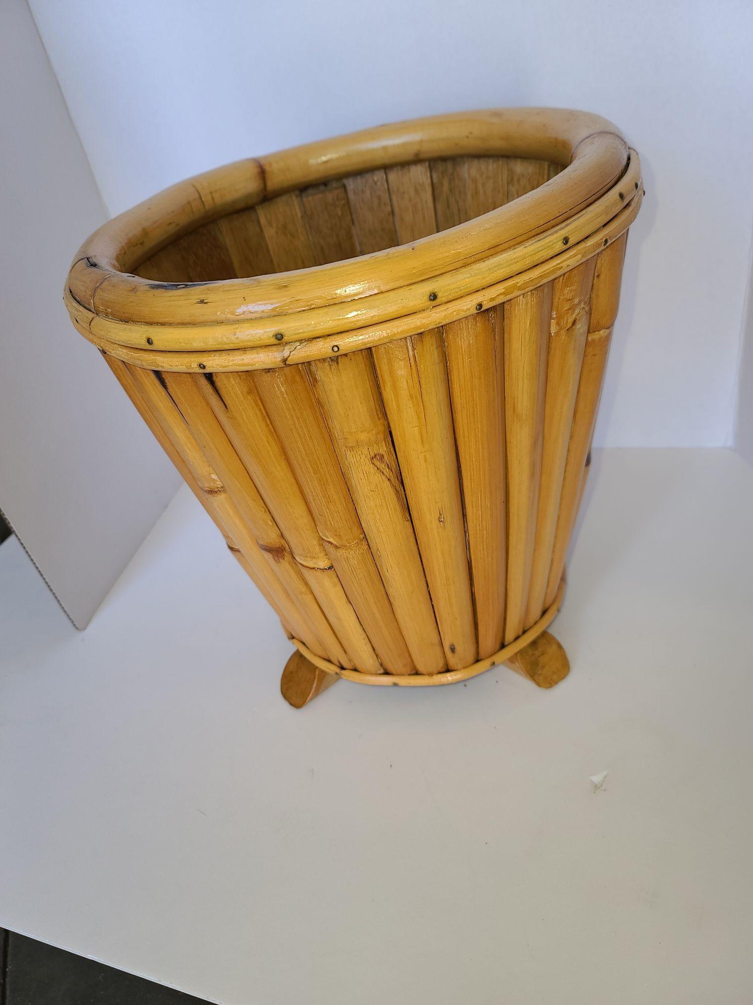 Original Paul Frankl rattan wastebasket featuring a stacked rattan basket fixed to a mahogany base. This basket comes from a Paul Frankl house in Encino California. Please contact the showroom for more details.

We only purchase and sell only the